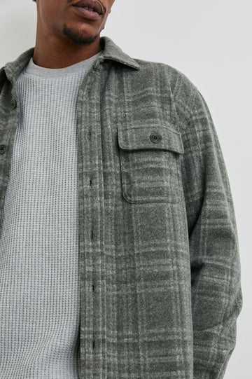 Alder Long-Sleeve Button up with Two Buttoned Chest Flap Pockets in Mossy Glen Colorway, a plaid - Front Unbuttoned View Featured on Model