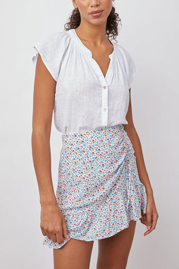 Alena Short Sleeve Top with Flutter Sleeves, a V Neck, Buttons Down the Bodice and Ruching along the Collar in Petal Colorway - Front Tucked View Featured on Model