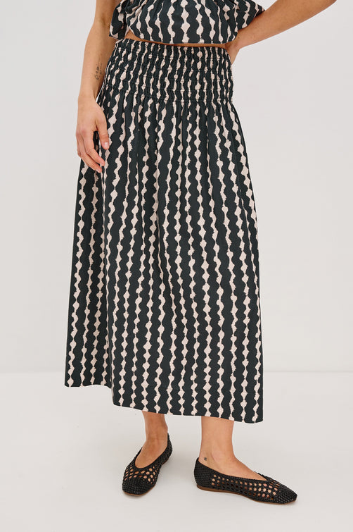 Alessa Midi Skirt with a Wide Elastic Gathered Waistband in Painted Noir Colorway. Front View Shown on Model.