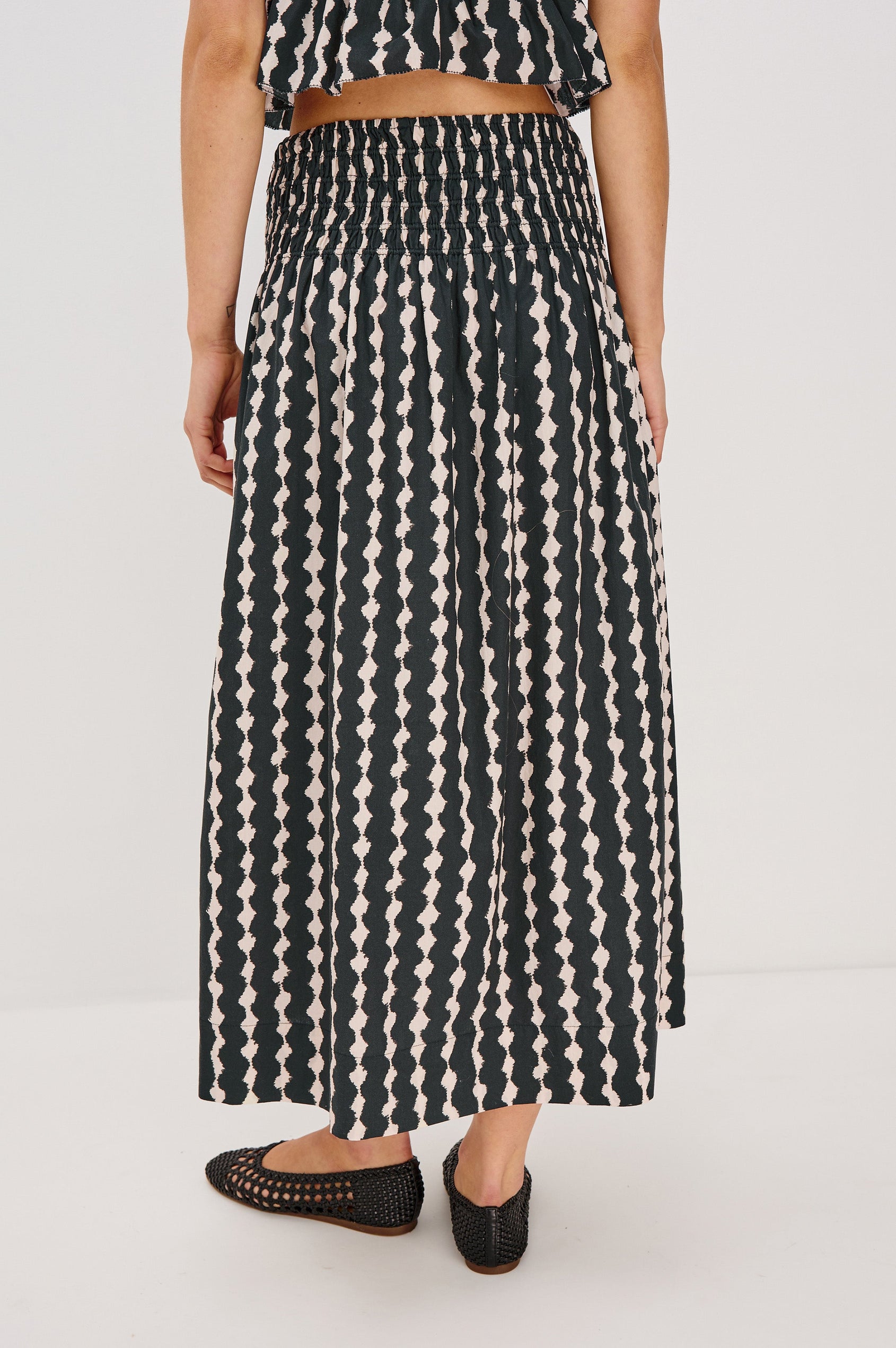 Alessa Midi Skirt with a Wide Elastic Gathered Waistband in Painted Noir Colorway. Back View Shown on Model.