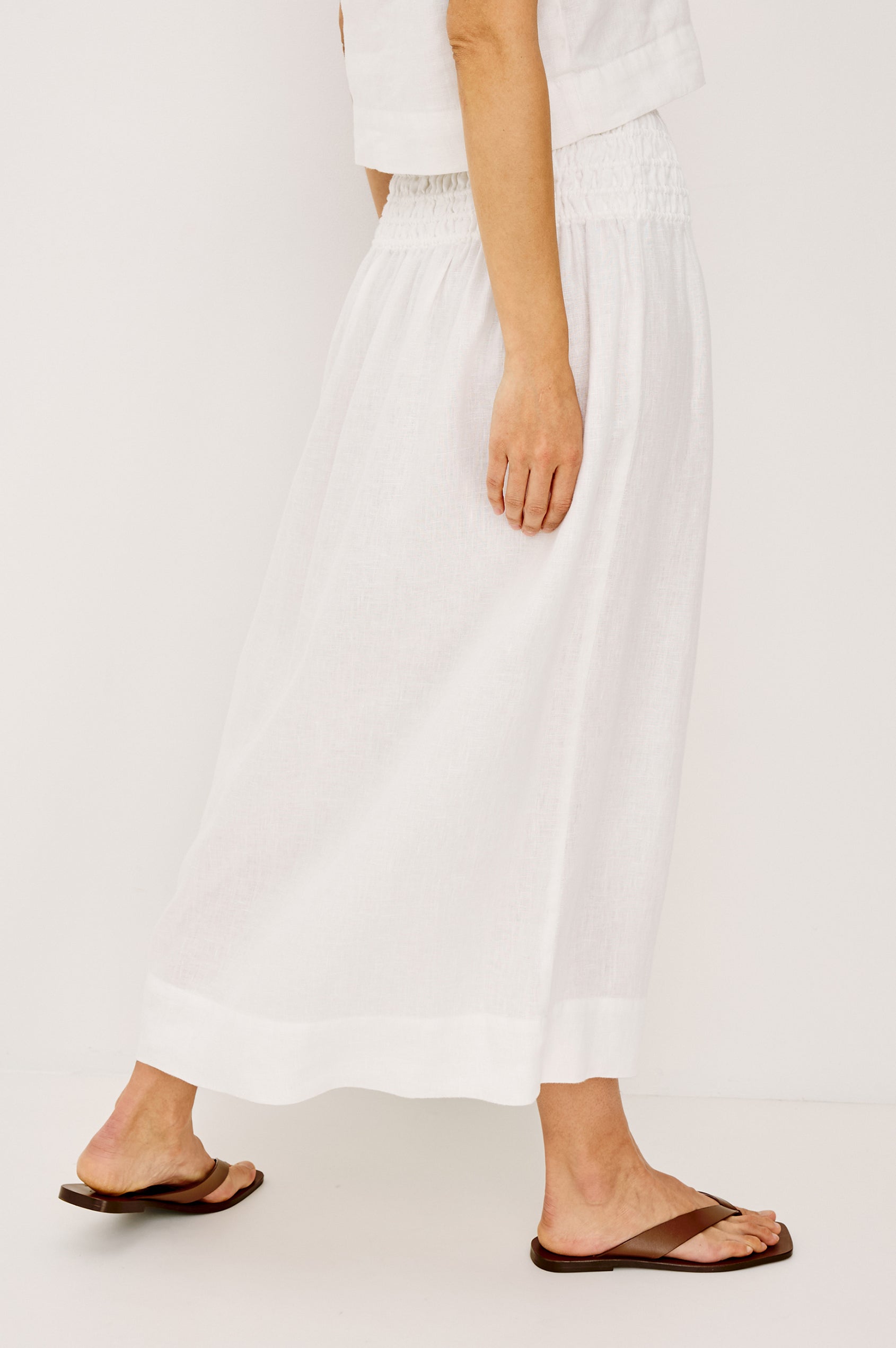 Alessa Midi Skirt in Heavy Linen With Wide Smocked Waistband and A-Line Silhouette in White Colorway - Lower Body Back View Featured on Model