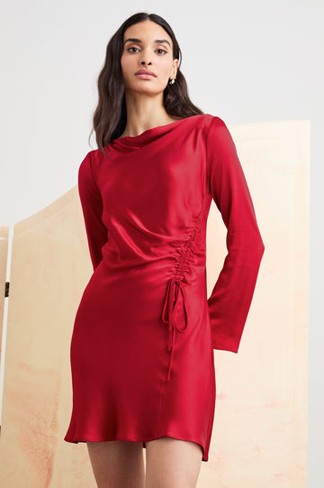 Alessandra Long Sleeve Mini Dress with a Slight Cowl at the Neck and Ruching with a Drawstring on the Left Side in Scarlet Colorway - Front View Featured on Model