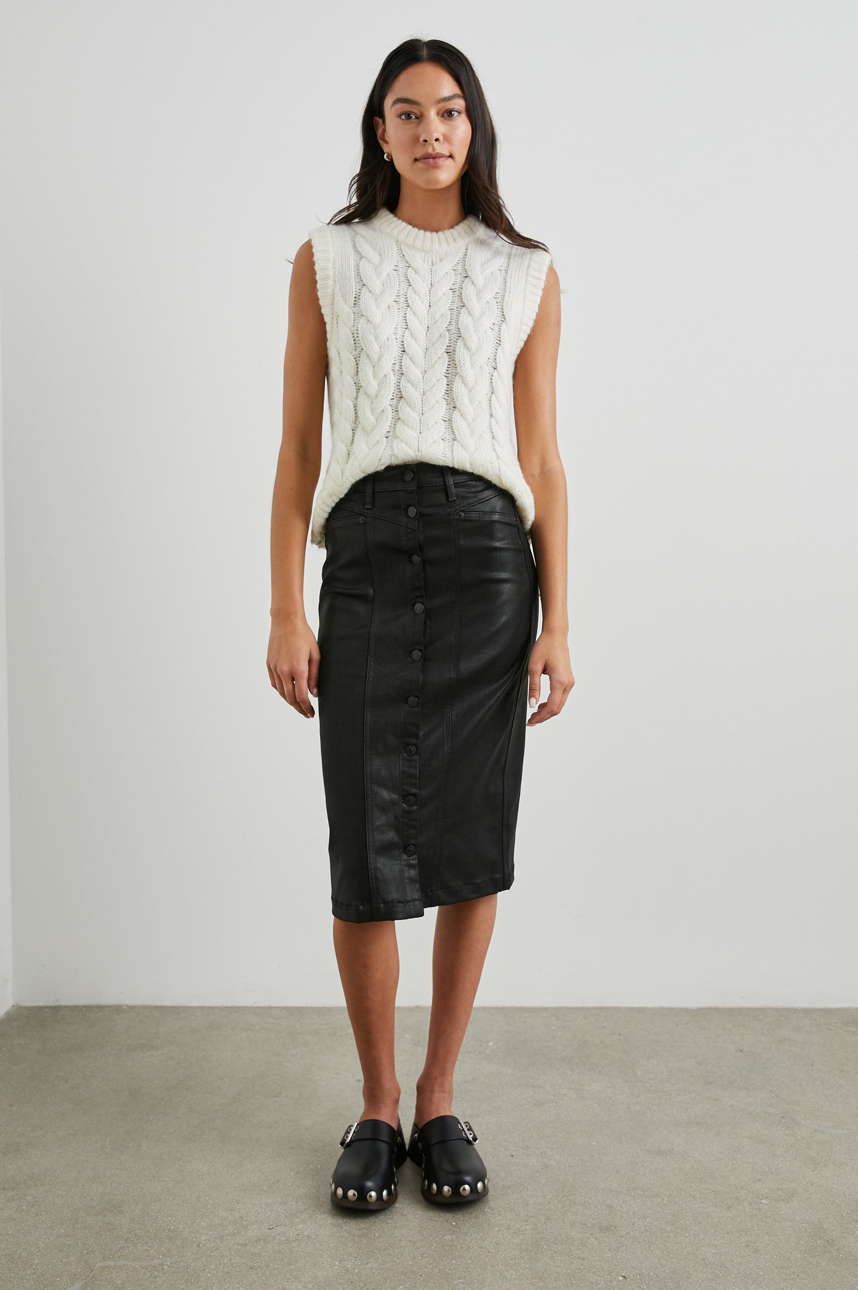 Alexis Sleeveless Cable Knit Sweater Vest with a Crew Neck and Ribbed Trim in Ivory Colorway - Front Full Body View Featured on Model 