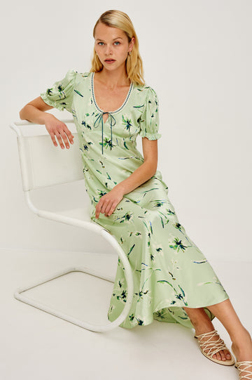 Allison Milkmaid-Inspired Maxi Dress in Satin Crepe Bias Cut With Short Puff Sleeves, Lace Scoop Neckline, and Ribbon Trim in Mint Linnea Colorway - Full Body View of Model Sitting Featured