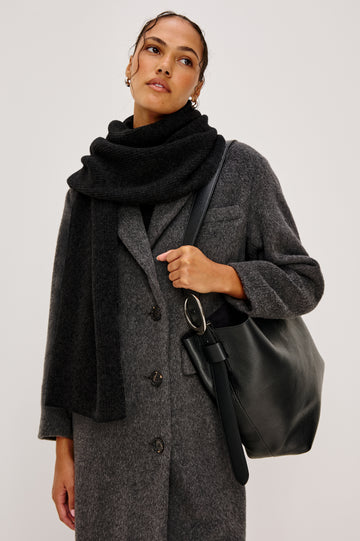 Alps knitted cashmere blend scarf in Black coloraway. Front view featured on model.