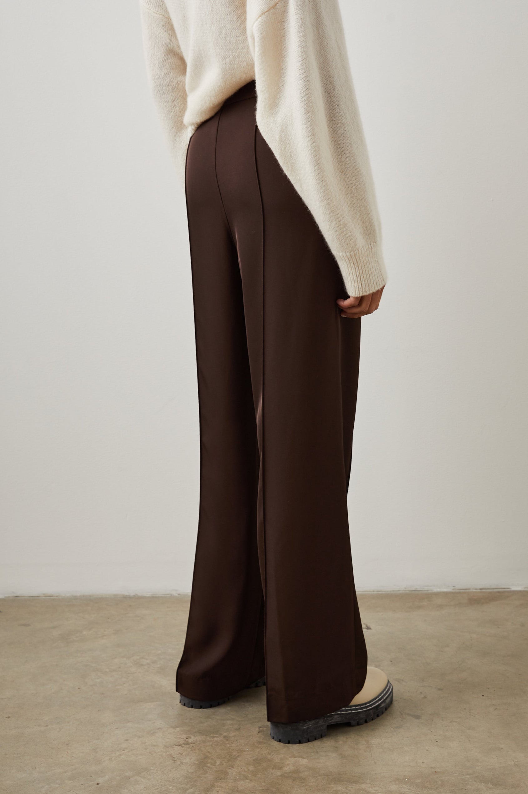Alta Pants with a Front and Back Center Vertical Leg Pleat and Two Front Pockets in Espresso Colorway - Back View Featured on Model  