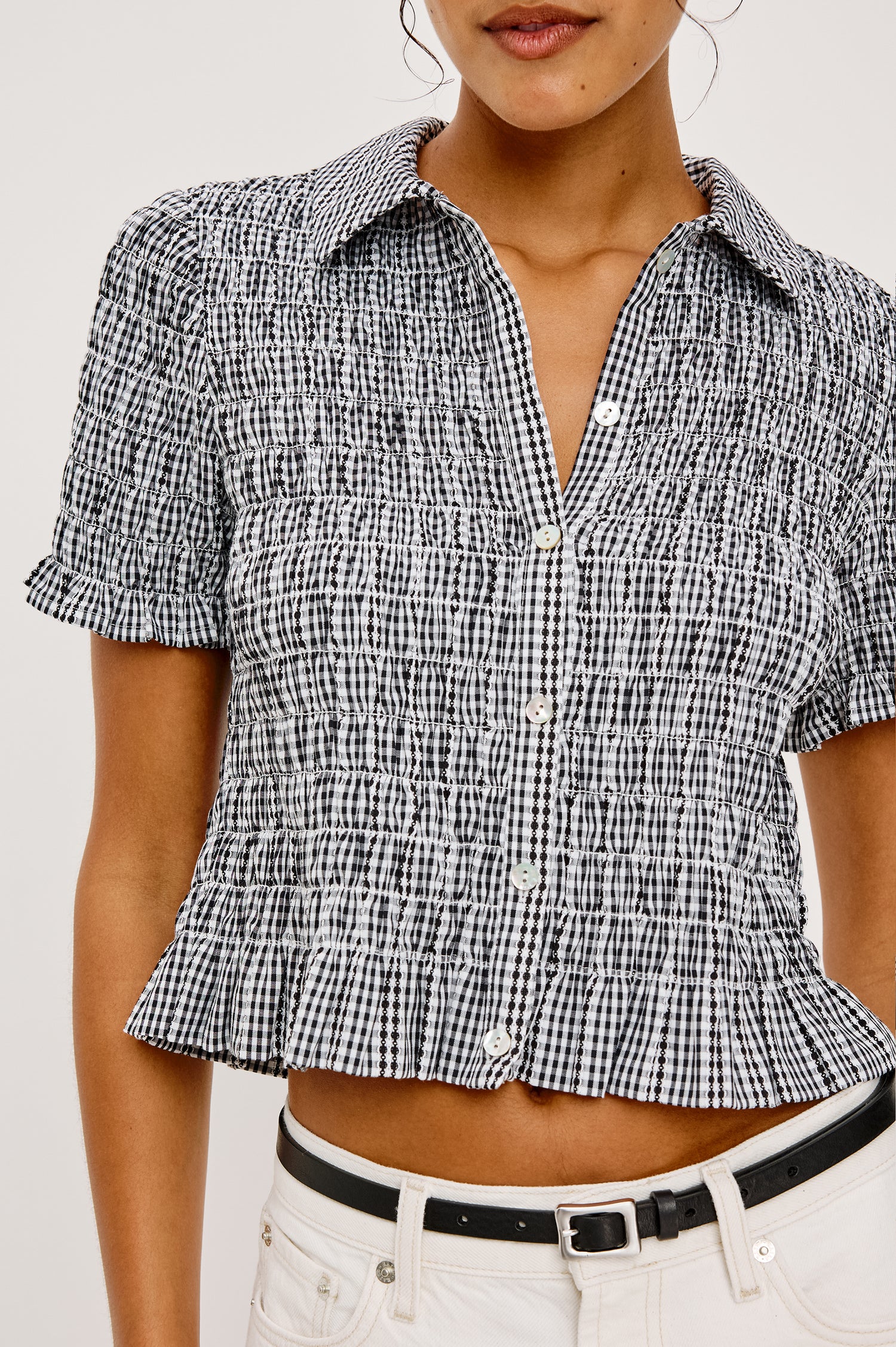 Alton Top in Cotton Poplin With Smocked Body Boxy Cropped Fit Collar Front Buttons Short Puff Sleeves and Ruffle Trim in Black Gingham Colorway - Upper Body Close Up Front View Featured on Model