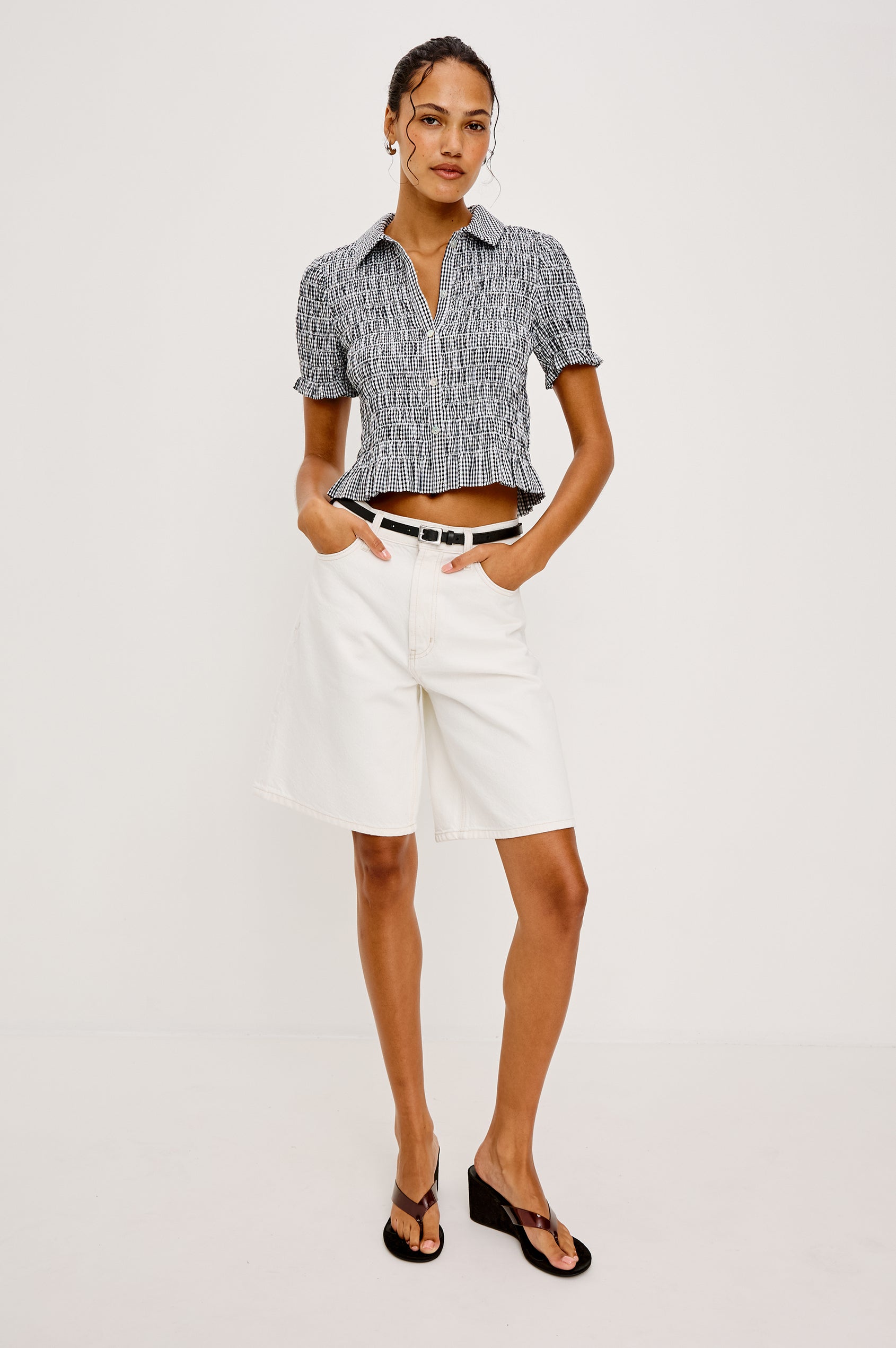 Alton Top in Cotton Poplin With Smocked Body Boxy Cropped Fit Collar Front Buttons Short Puff Sleeves and Ruffle Trim in Black Gingham Colorway - Full Body Front View Featured on Model
