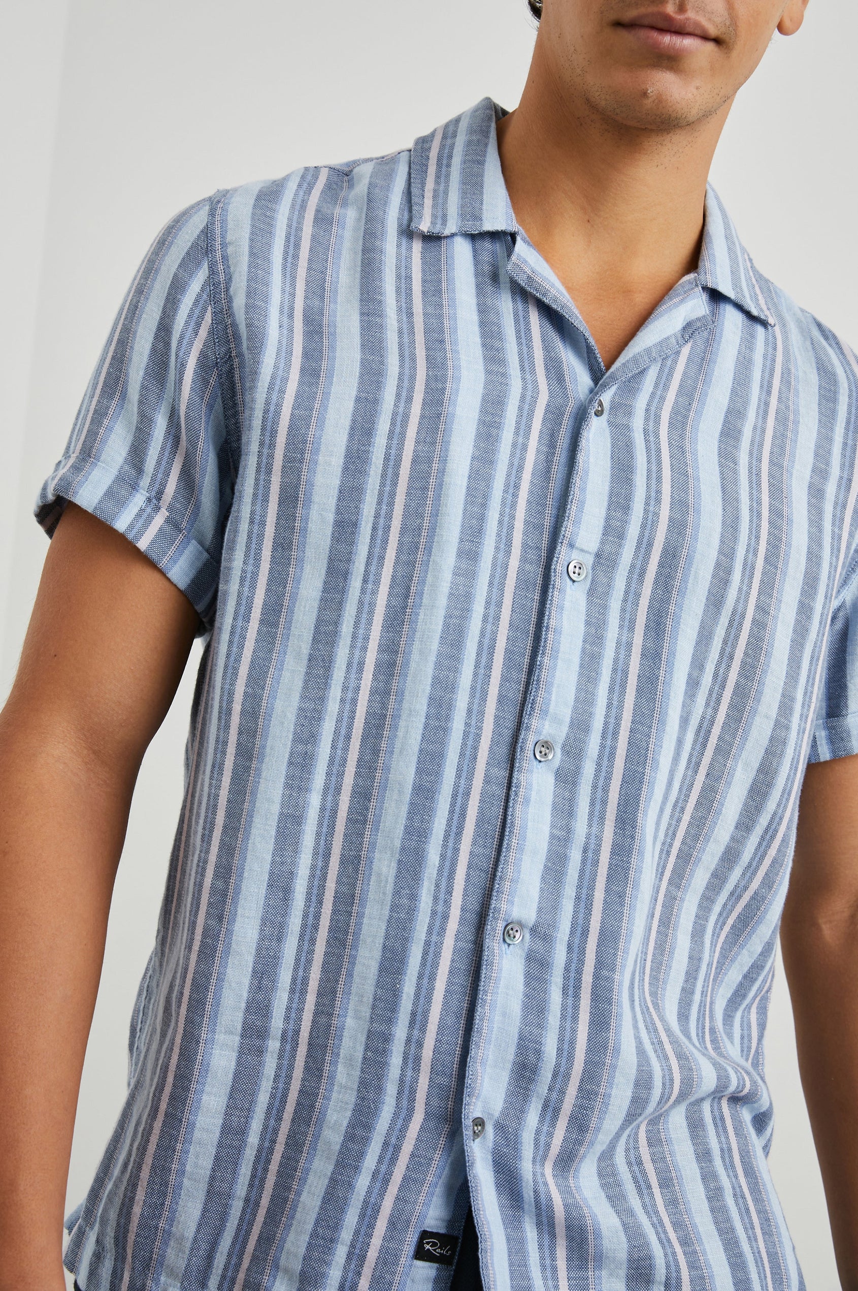 Amalfi Short-Sleeve Button Up in Powder Cobalt Stripe Colorway, vertical stripes in powder, cobalt and petal - Front View Featured on Model