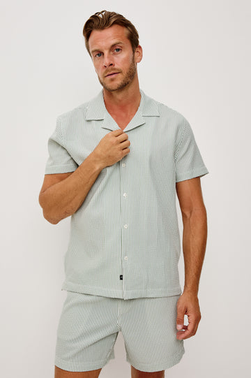 The Amalfi Button-Up Short Sleeve Shirt in Lightweight Stretch Linen-Blend With a Notched Collar and Classic Fit in Sage White Seersucker - Upper Body Front View Featured on Model