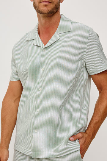 The Amalfi Button-Up Short Sleeve Shirt in Lightweight Stretch Linen-Blend With a Notched Collar and Classic Fit in Sage White Seersucker - Upper Body Close Up Front View Featured on Model