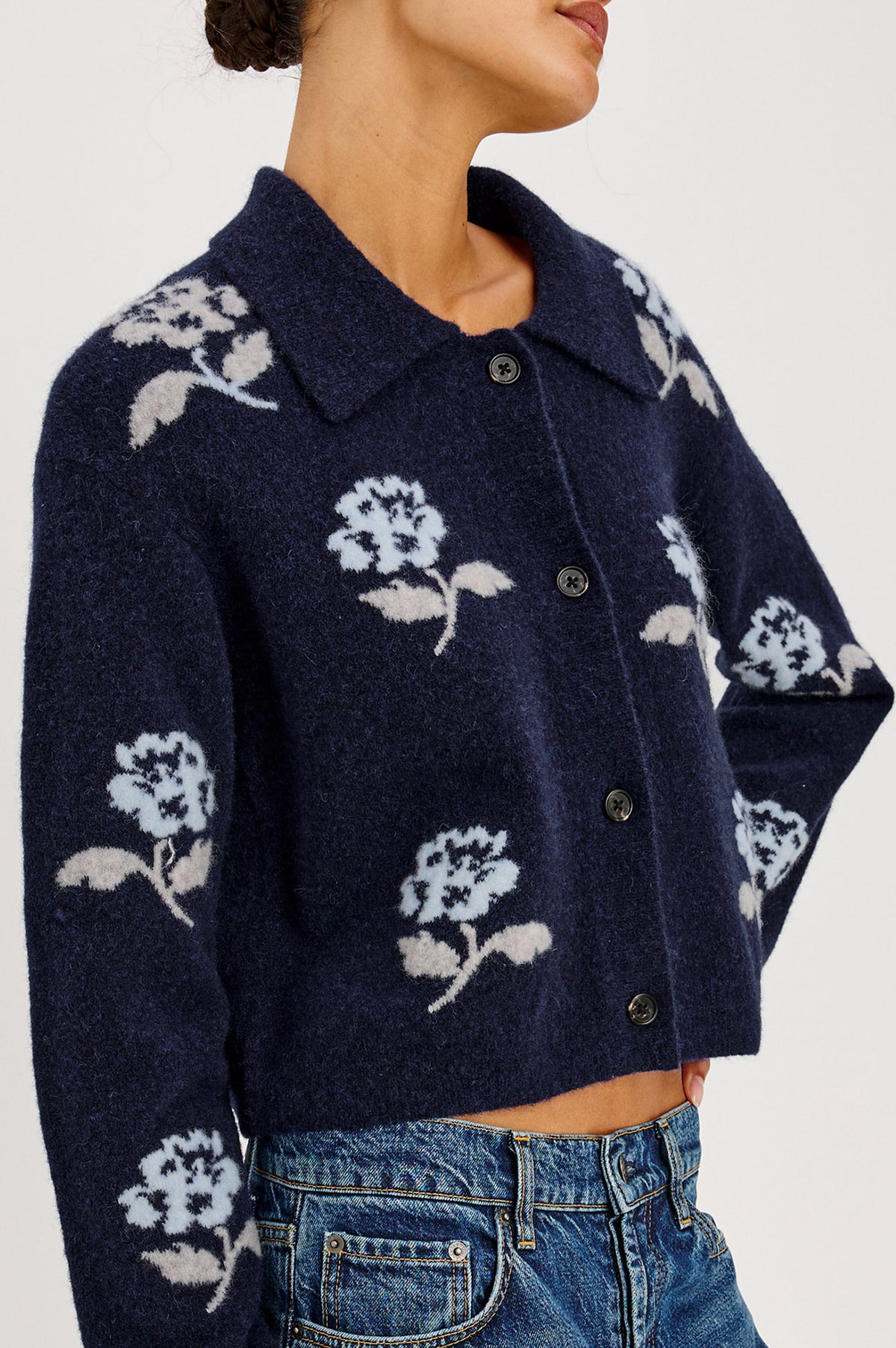 Amber Cardigan in Floral Jacquard Knit With Front Buttons, Point Collar, and Long Sleeves in Navy Petals Colorway - Upper Body Front Detail View Featured on Model.
