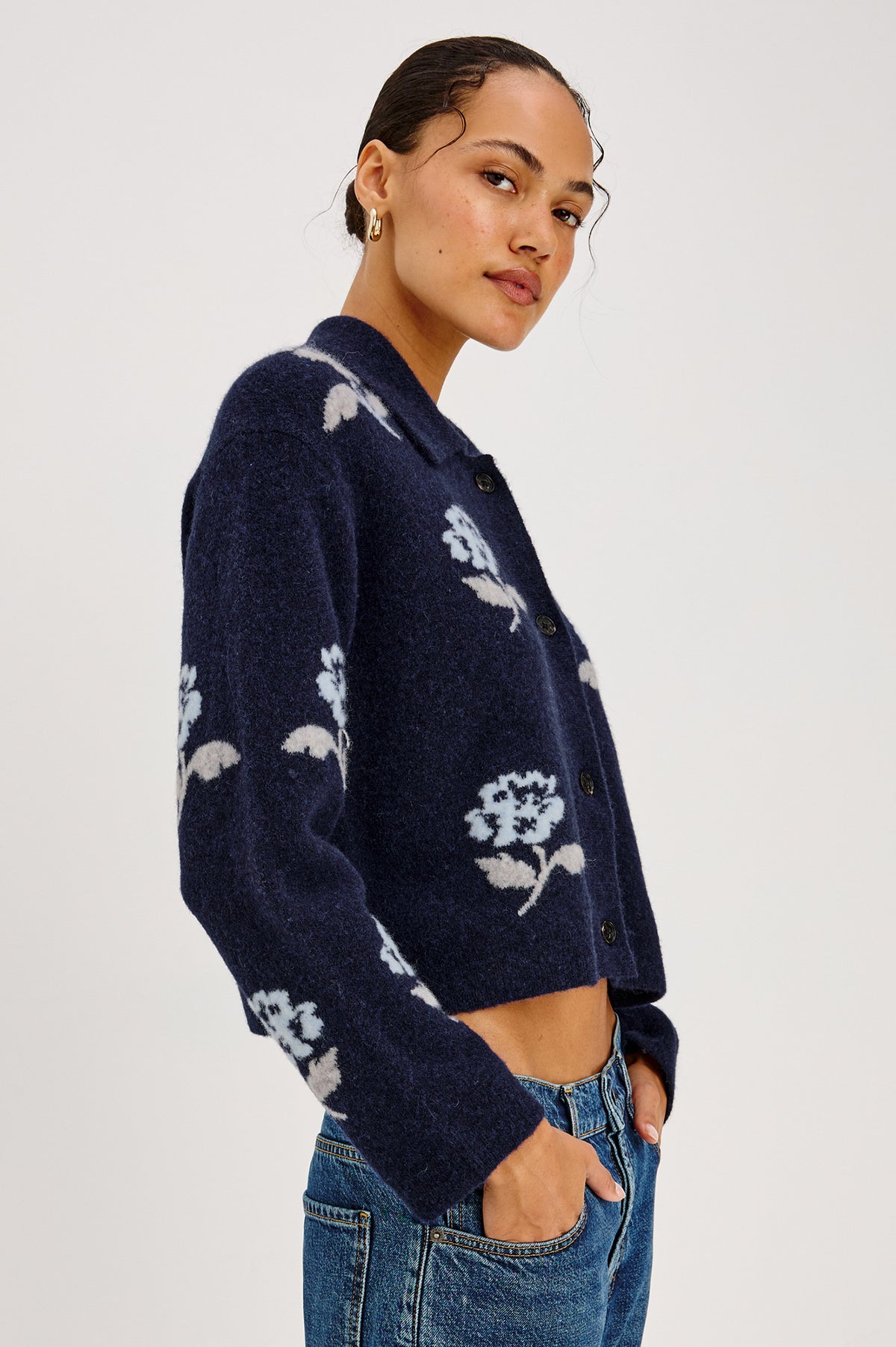 Amber Cardigan in Floral Jacquard Knit With Front Buttons, Point Collar, and Long Sleeves in Navy Petals Colorway - Front View Featured on Model.
