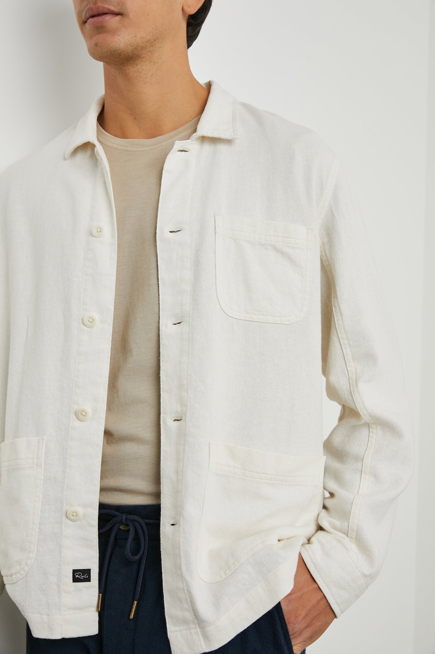 Ambrose Jacket with Button Closure and Two Front Patch Pockets and a Chest Patch Pocket in Ecru Colorway - Front View Featured on Model