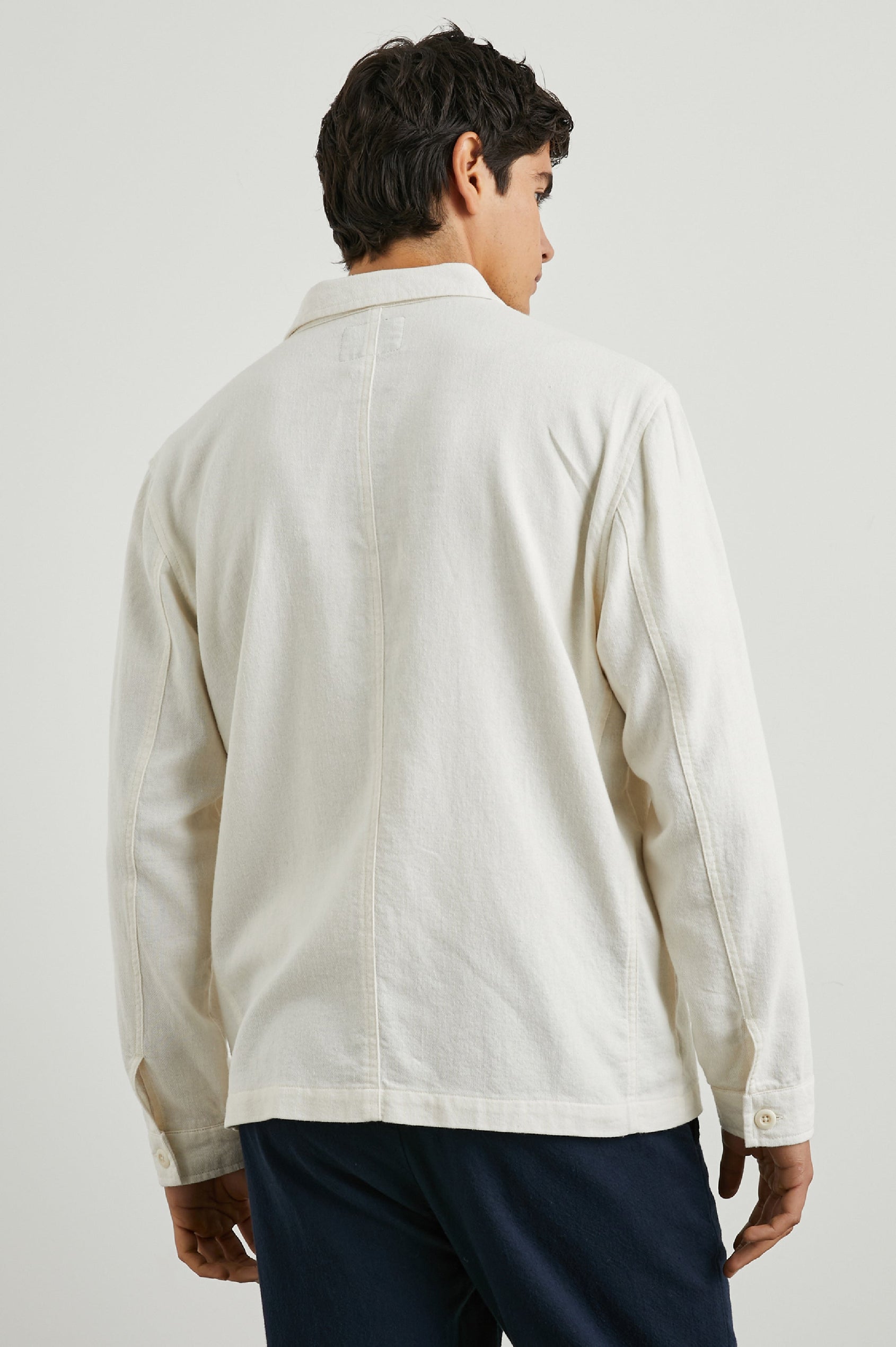 Ambrose Jacket with Button Closure and Two Front Patch Pockets and a Chest Patch Pocket in Ecru Colorway - Back View Featured on Model