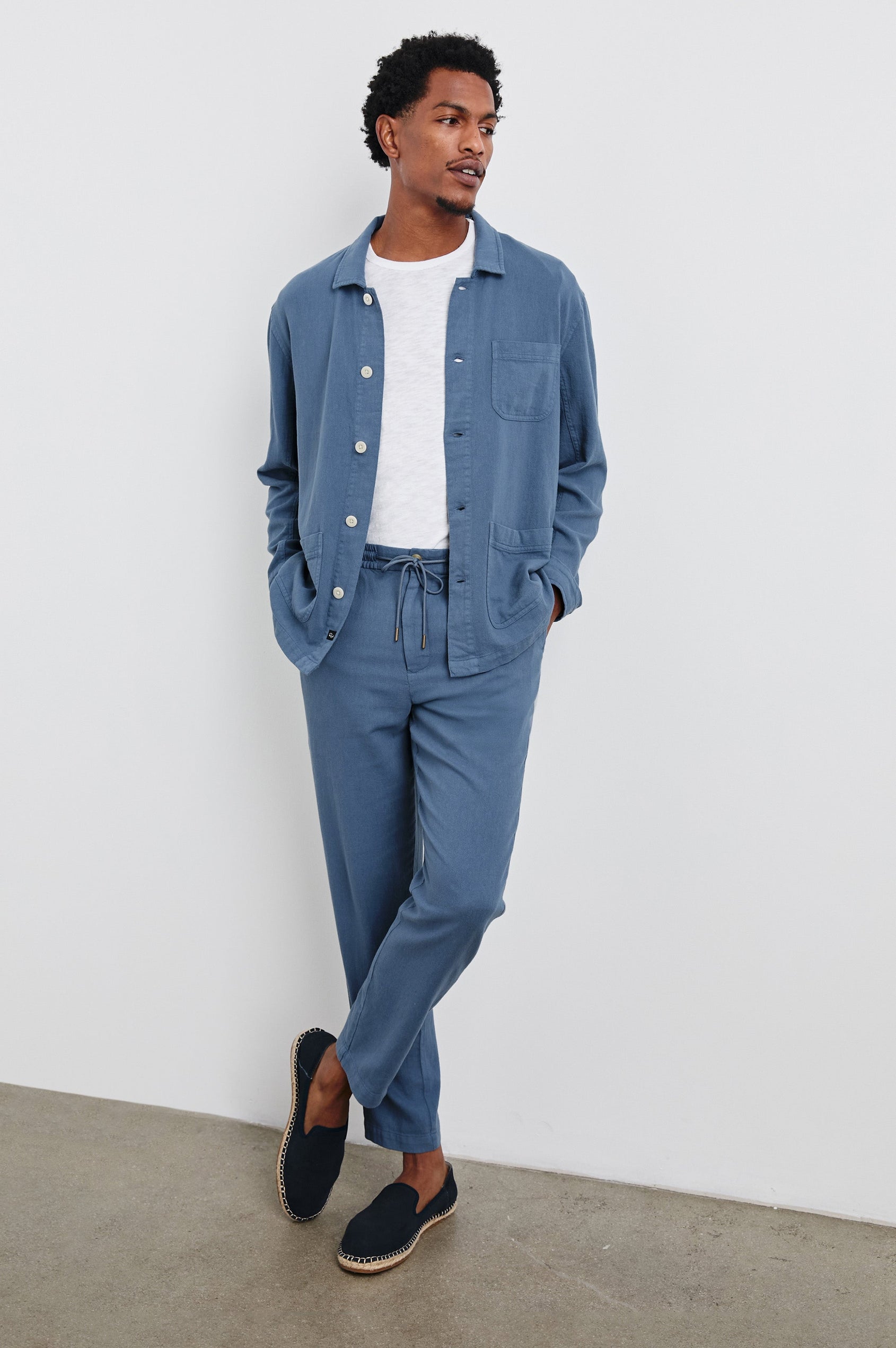 Ambrose Jacket with Button Closure, Tow Front Patch Pockets and a Chest Patch Pocket in Washed Blue Colorway - Front Full Body View Featured on Model