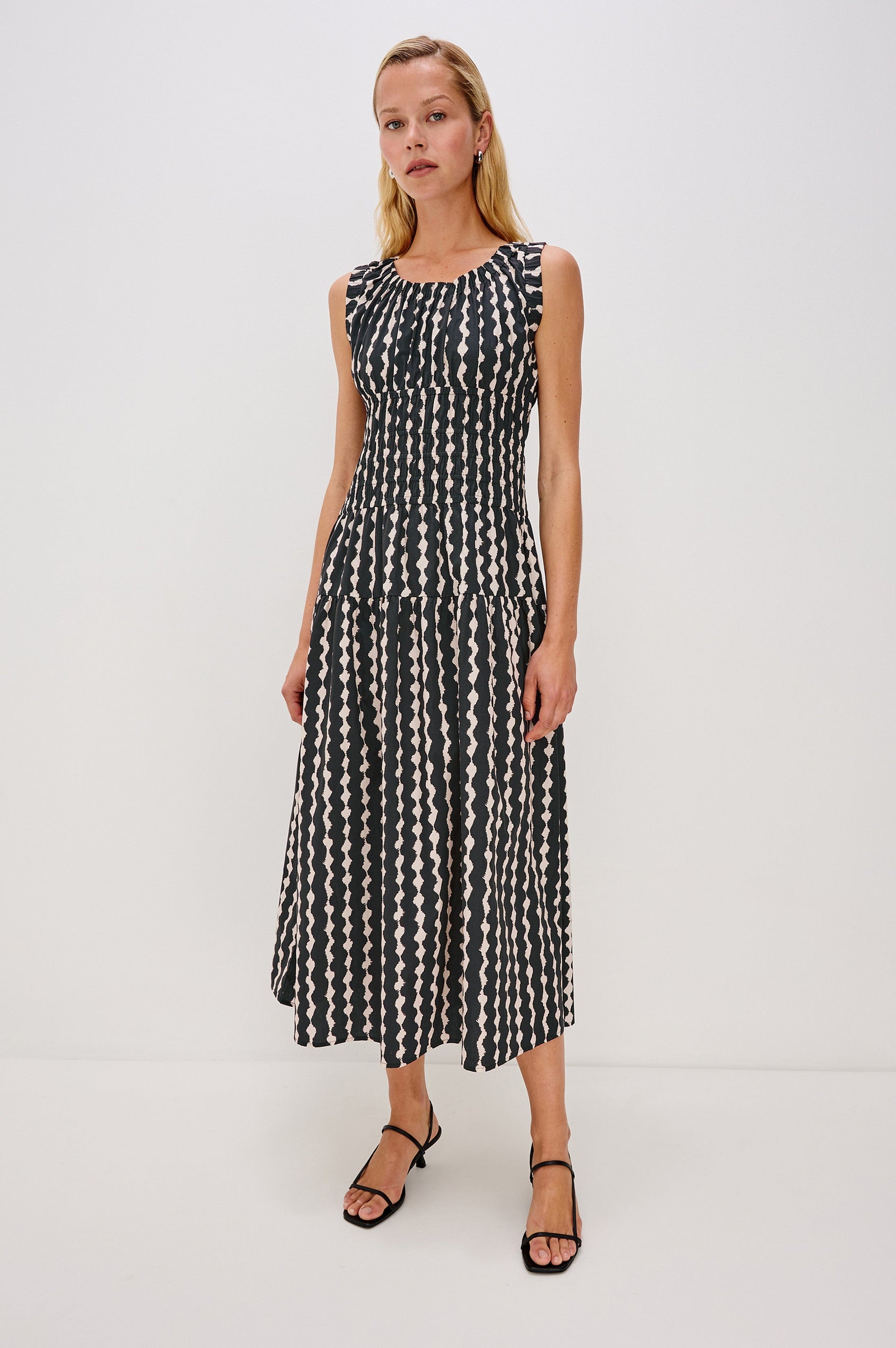 Anastasia Sleeveless Tiered Midi Dress with Shoulder Straps, a Scoop Neck and Ruching on the Bodice in Painted Noir Colorway - full body front view on model