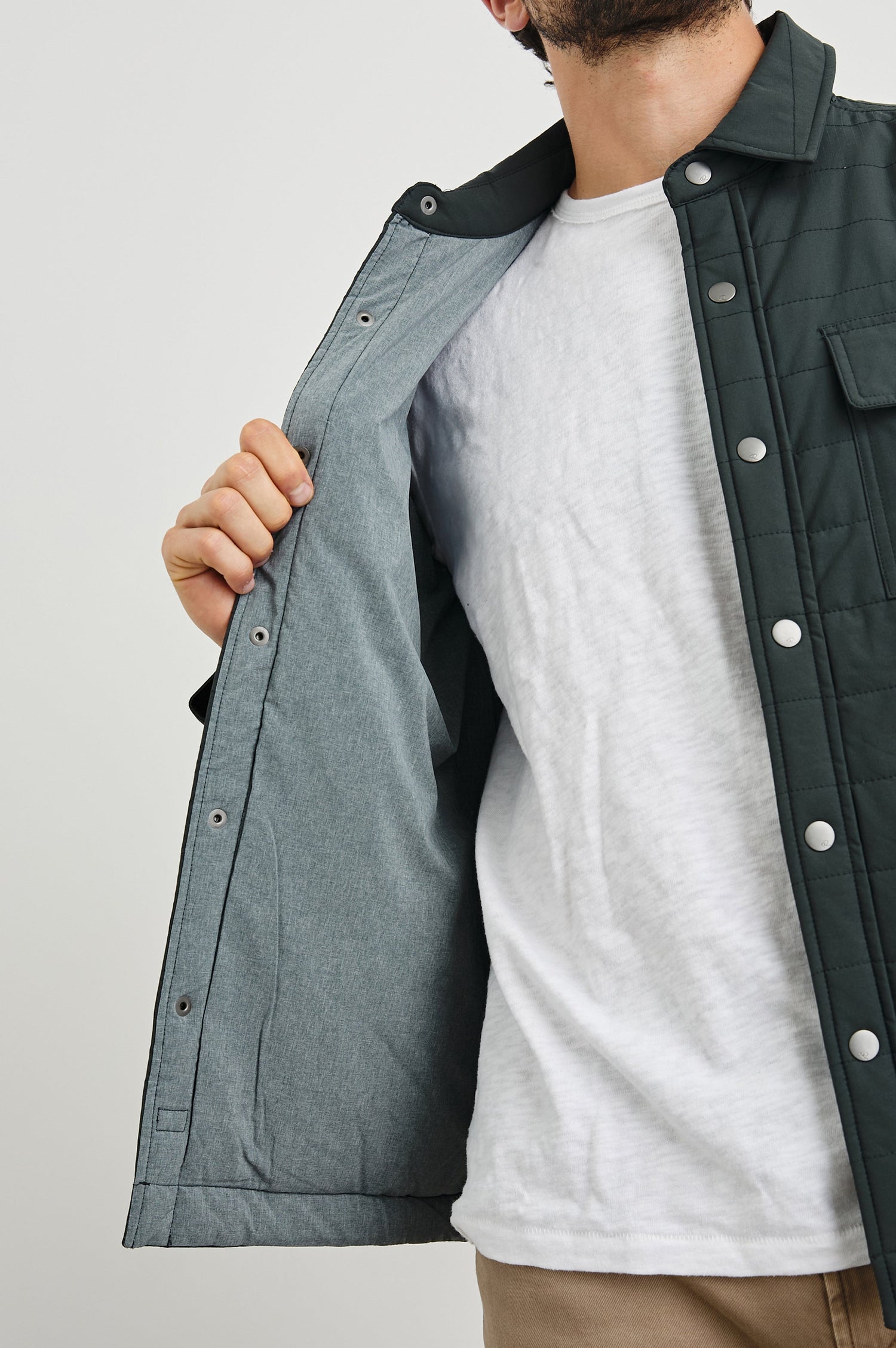 Andover Quilted Puffer Jacket with Snap Closure, Two Chest Snap Flap Pockets, and Two Front Pockets in Black Colorway - Front View Featured on Model  