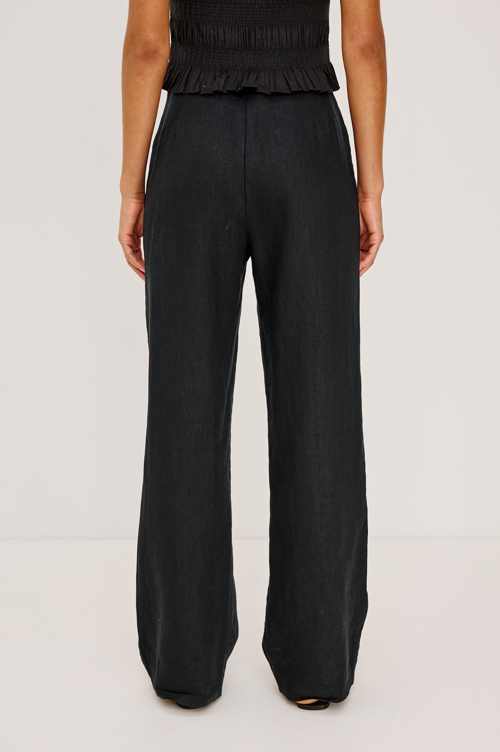 Andrine Pant in Heavy Linen With High-Waisted Fit, Straight Legs, Unlined, Side On-Seam Pockets, Side Zip Closure in Black Colorway - Lower Body Front View Featured on Model