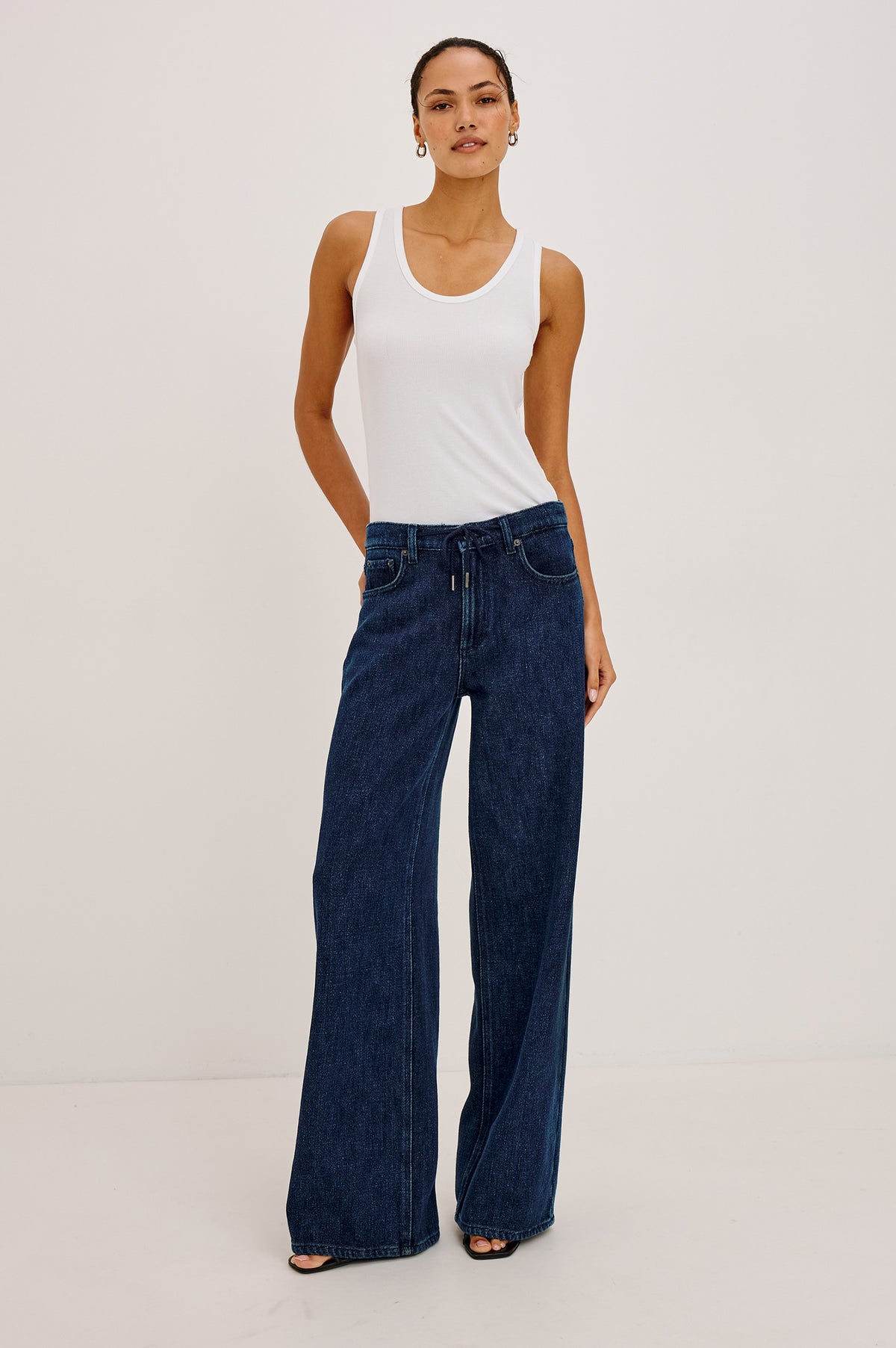 Angeleno Wide Leg Jean With Mid-Rise Relaxed Fit, Wide Legs, Drawstring Waist Ties, Hidden Stretch, and 5-Pockets in Imperial Blue Colorway - Full Body Front View Featured on Model