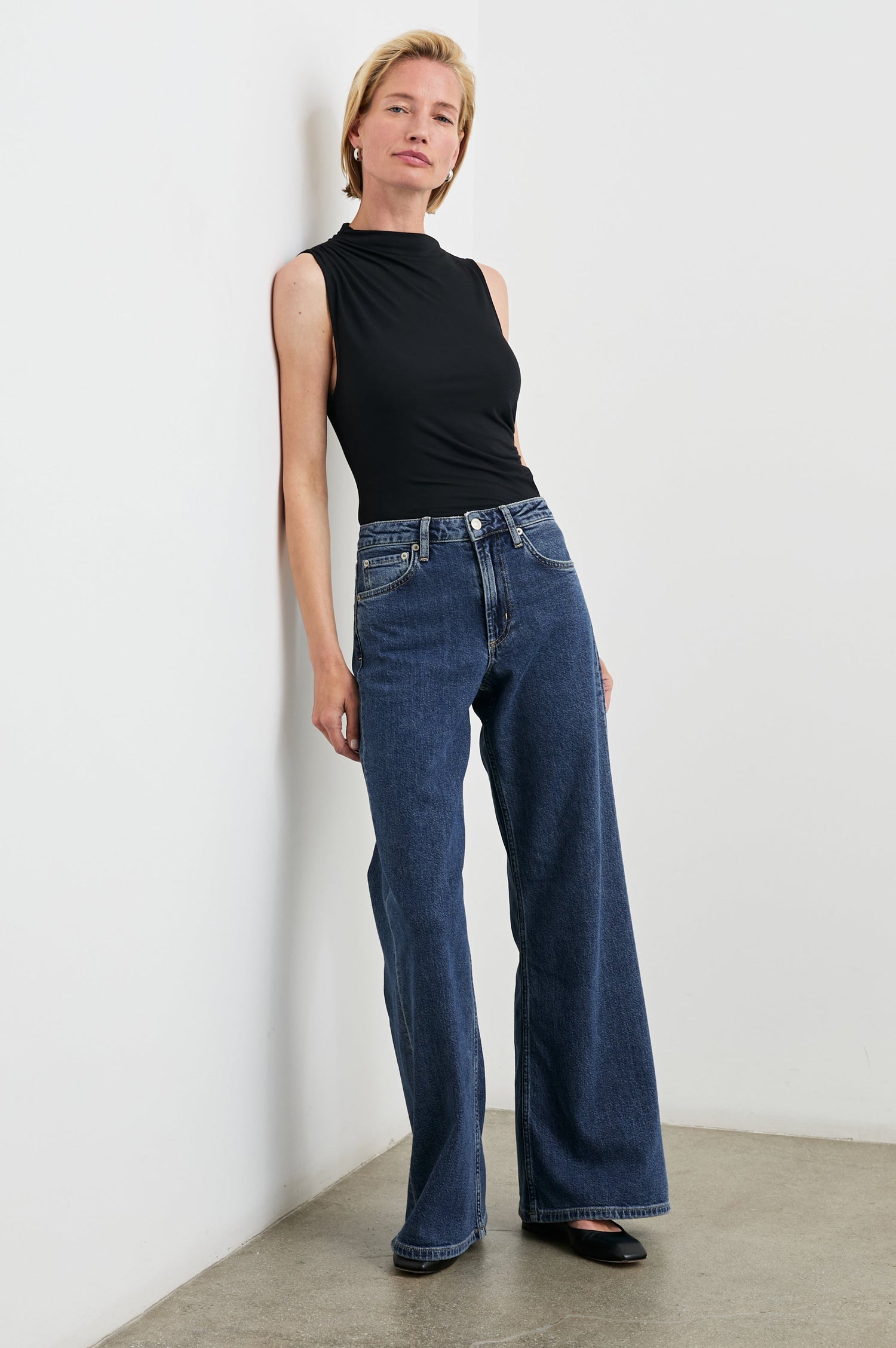 Angeleno Wide Leg Denim Pants with Belt Loops, Two Front Pockets and Two Back Patch Pockets in Pebble Blue Colorway - Front Full Body View Featured on Model