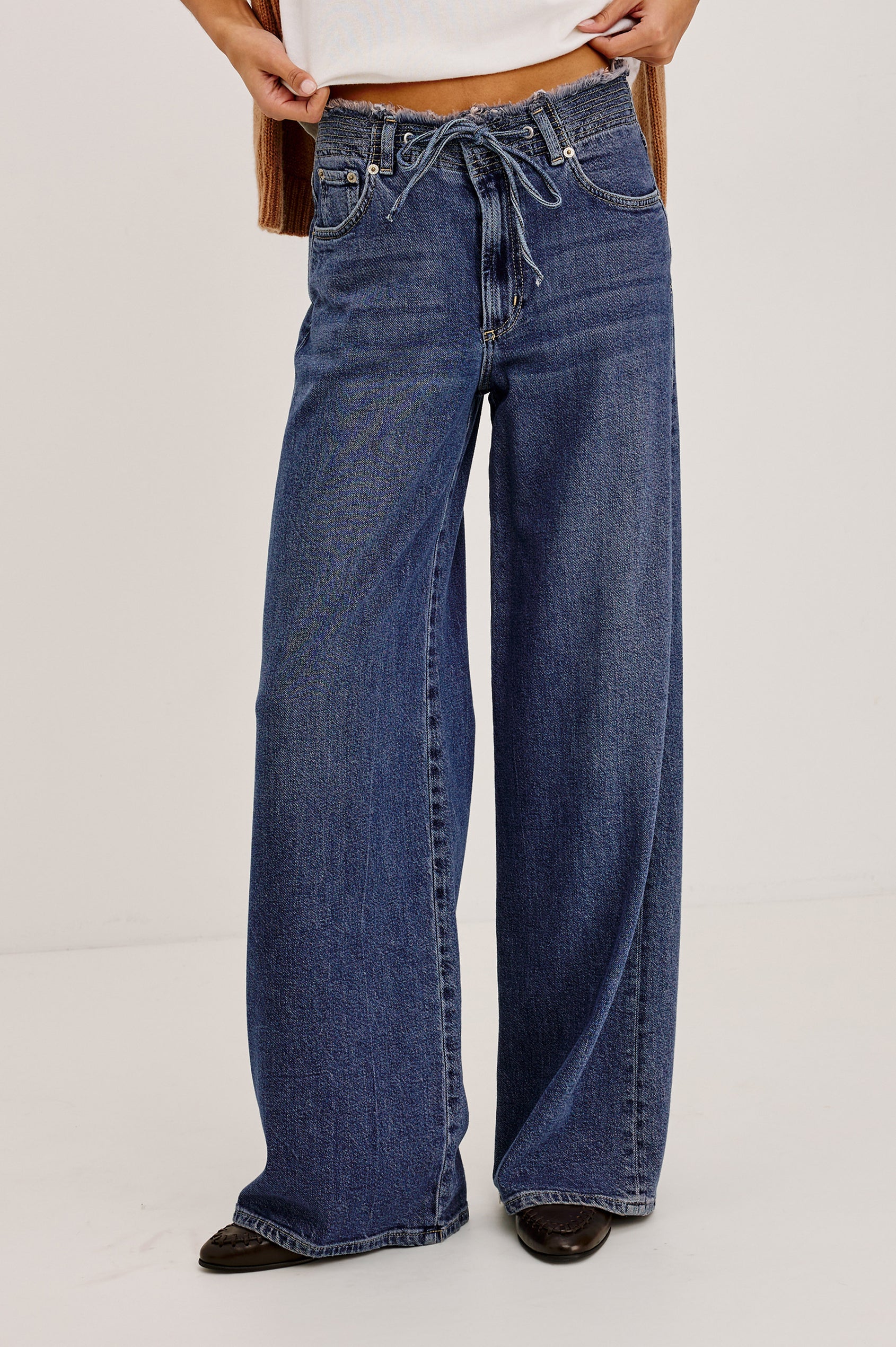 Angeleno Wide Leg in Rigid Denim With Hidden Stretch, Relaxed Mid-Rise Fit, 5-Pockets, Self-Tie Shoelace Belt, and Frayed Waistband in River Colorway - Lower Body Front View Featured on Model