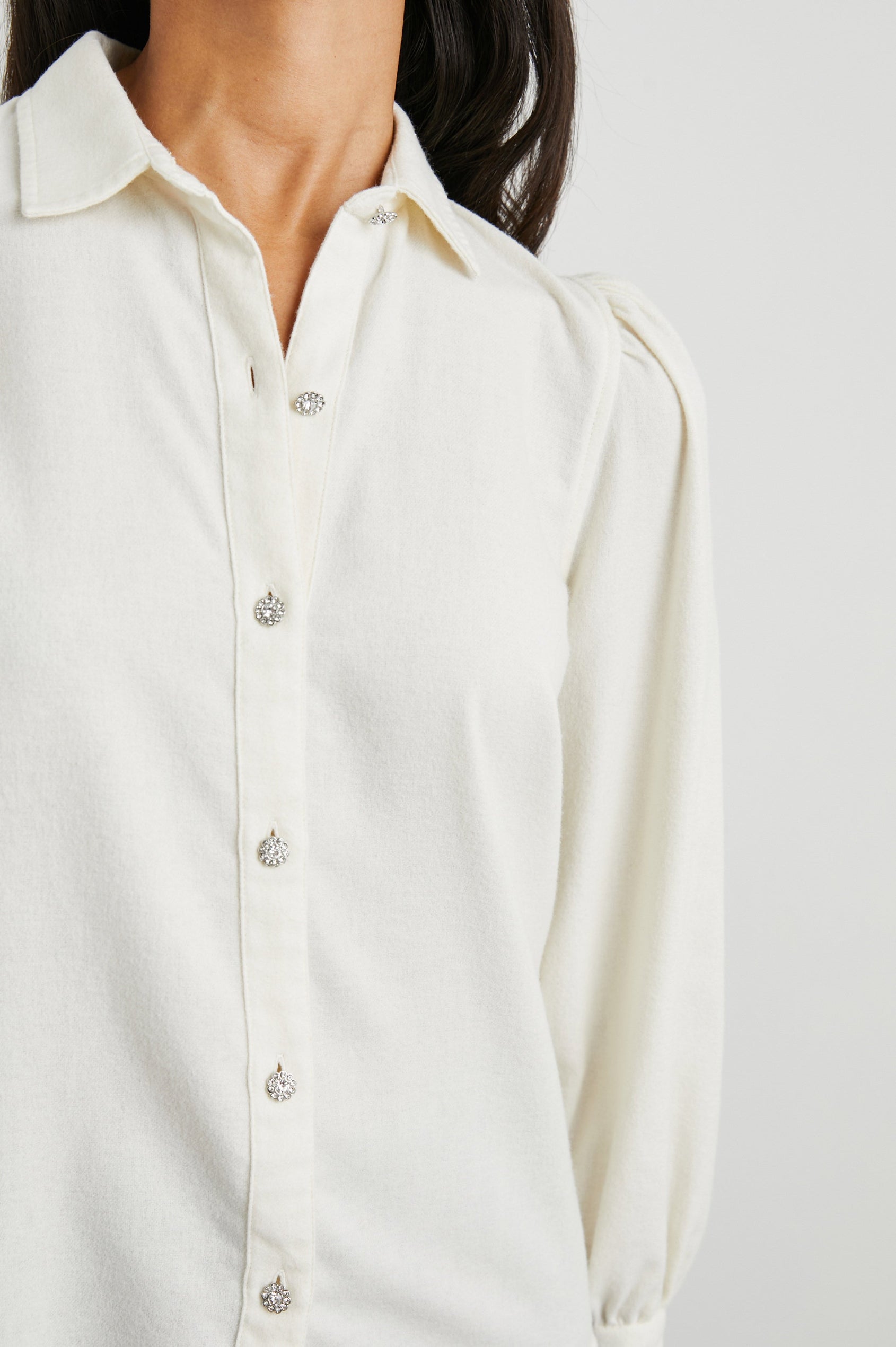 Angelica Long-Sleeve Button Up with Shirring at Cuffs, Puff Sleeves and Crystal Flower Buttons in Winter White Colorway - Front View Featured on Model