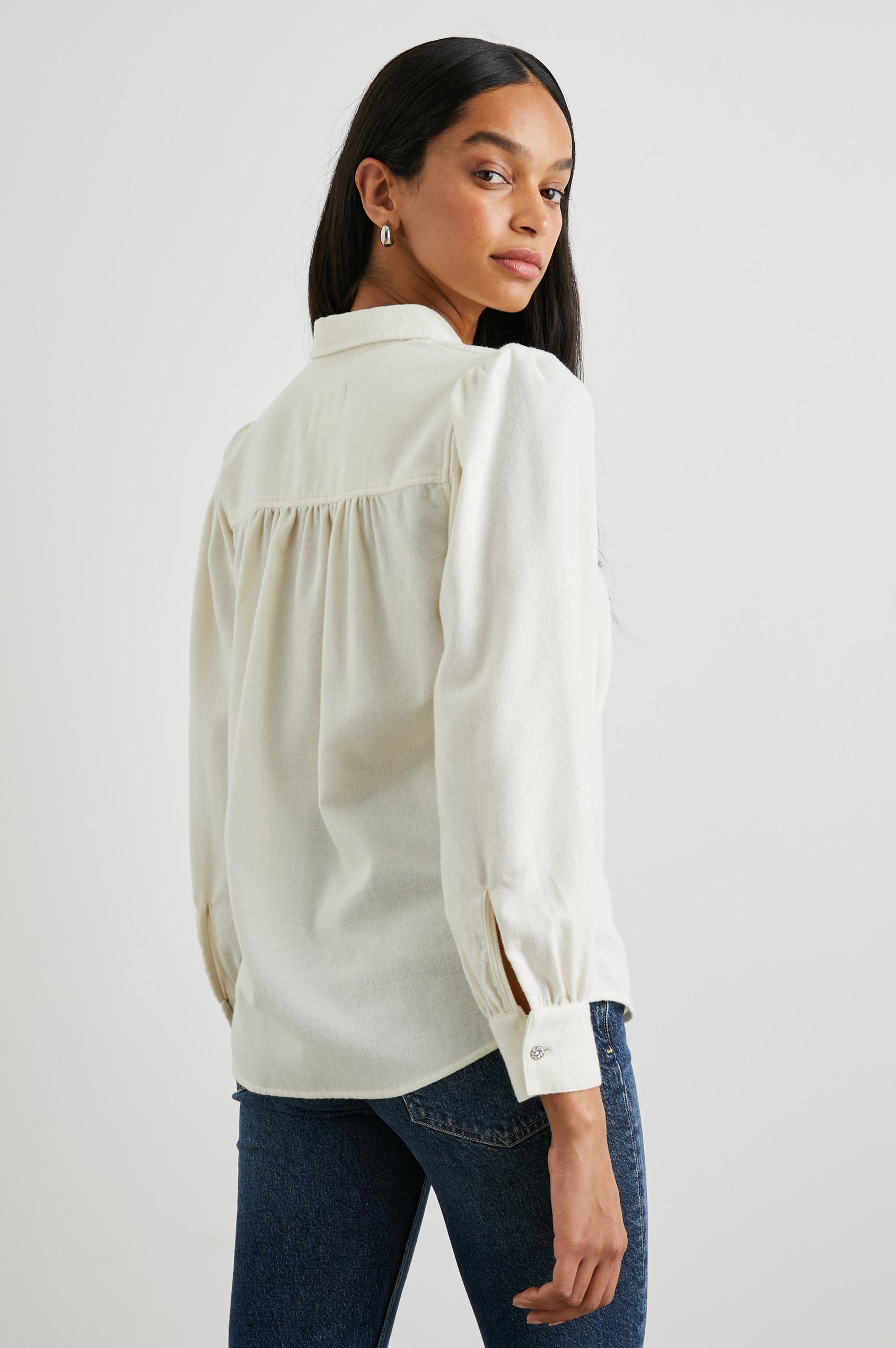 Angelica Long-Sleeve Button Up with Shirring at Cuffs, Puff Sleeves and Crystal Flower Buttons in Winter White Colorway - Back View Featured on Model