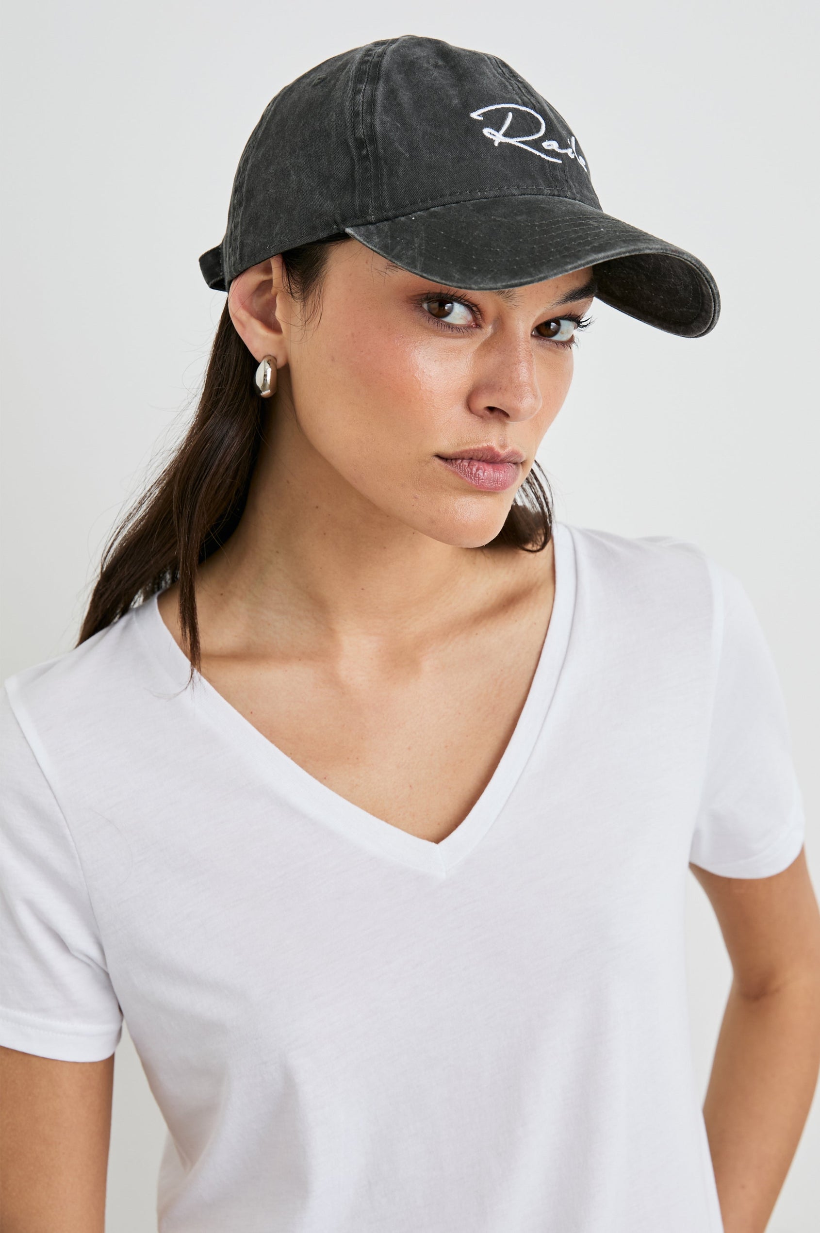 Anniversary Baseball Cap with an Adjustable Back Strap, Front Text, Rails, and Back Text, Est 2009, in Washed Black Colorway, with White Text - Front View Featured on Model