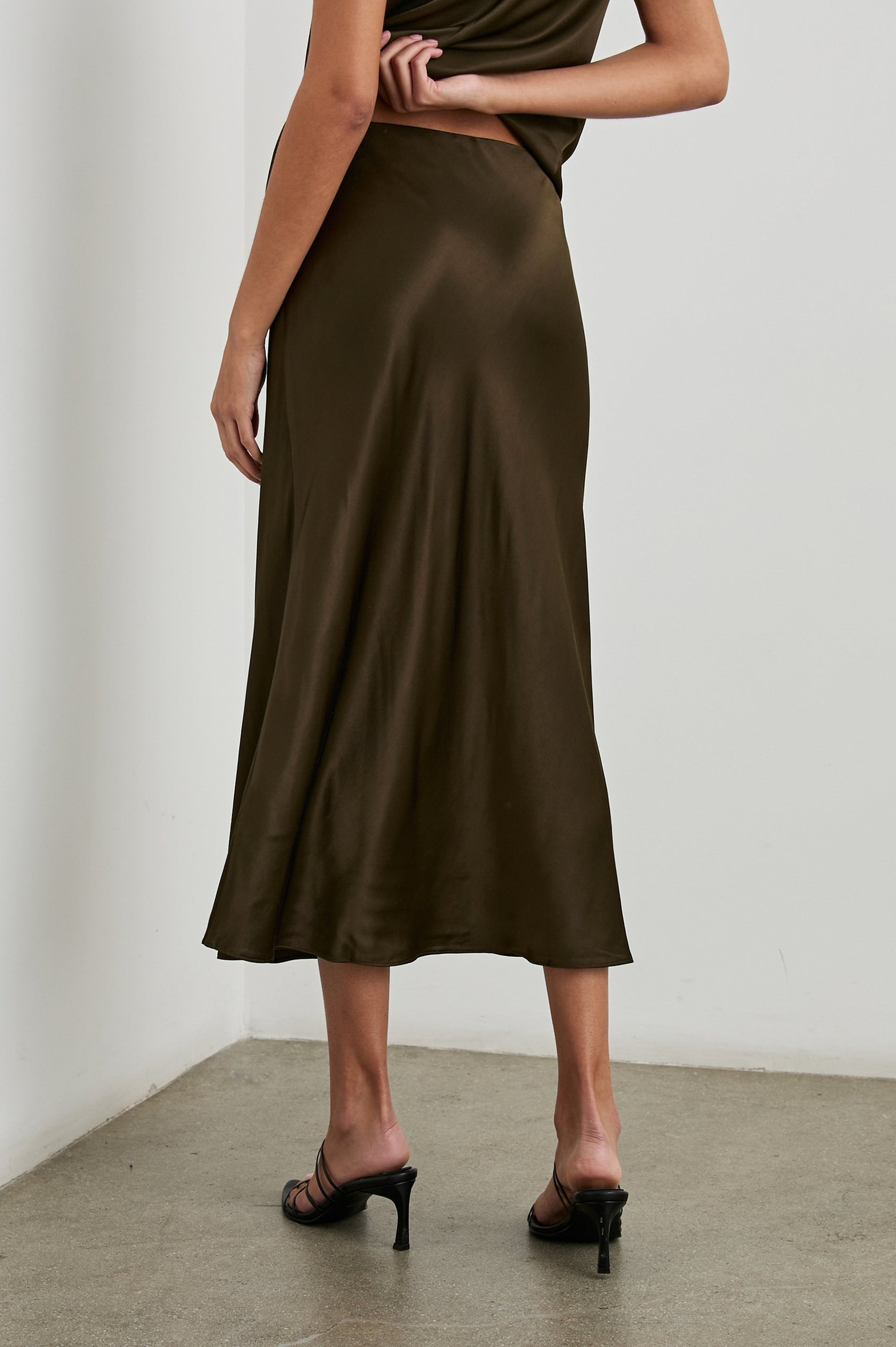 Anya High-waisted Midi Skirt in Dark Moss Colorway - Front View Featured on Model
