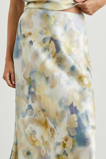 Anya High-waisted Midi Skirt in Diffused Blossom Colorway, with flowers in Creams, Golds and Blues on White - Front View Featured on Model