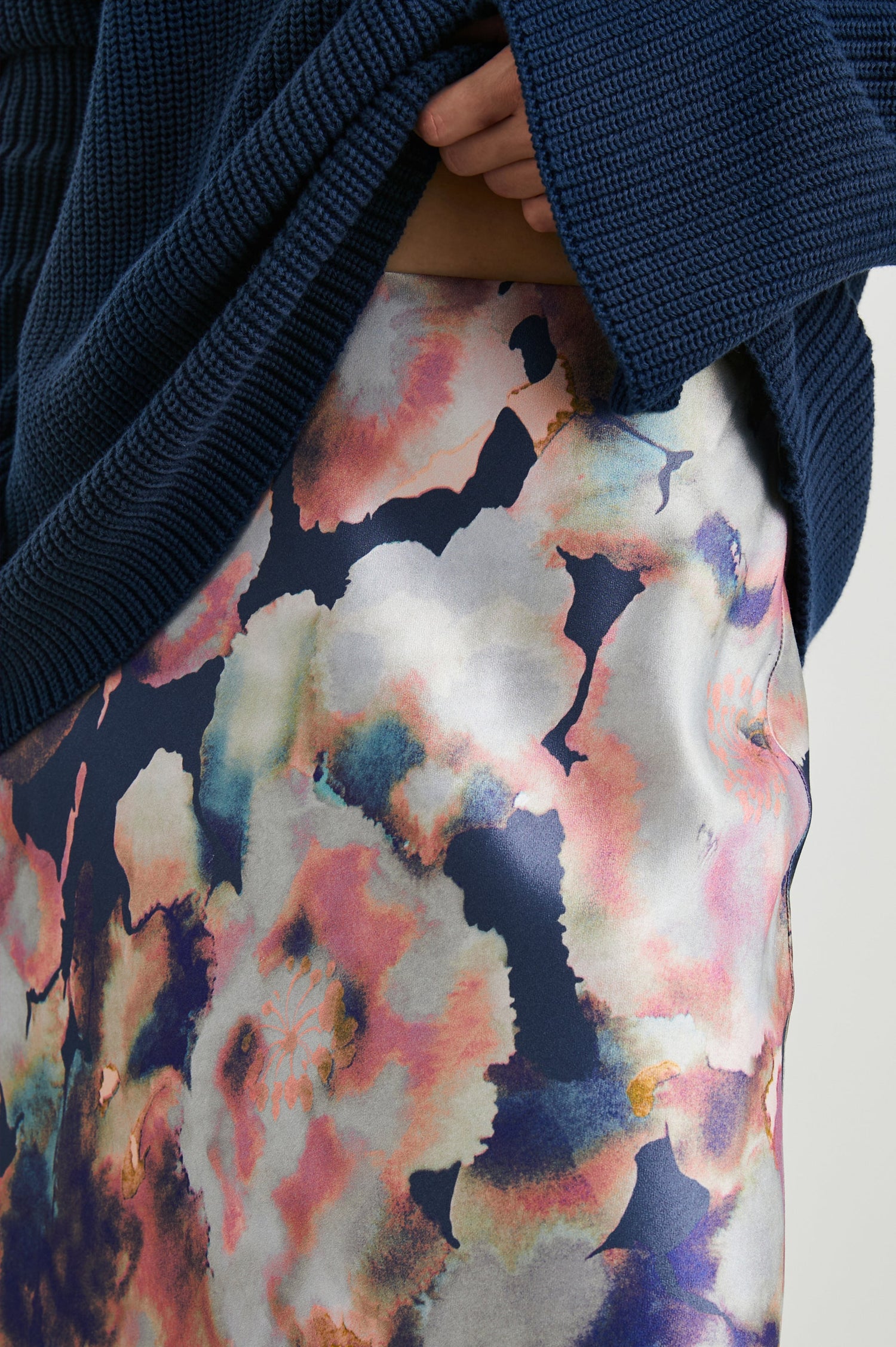 Anya High-waisted Midi Skirt in Midnight Verbena Colorway, Flowers in Pinks, Purples, Oranges and Blues on dark blue - Front View Featured on Model