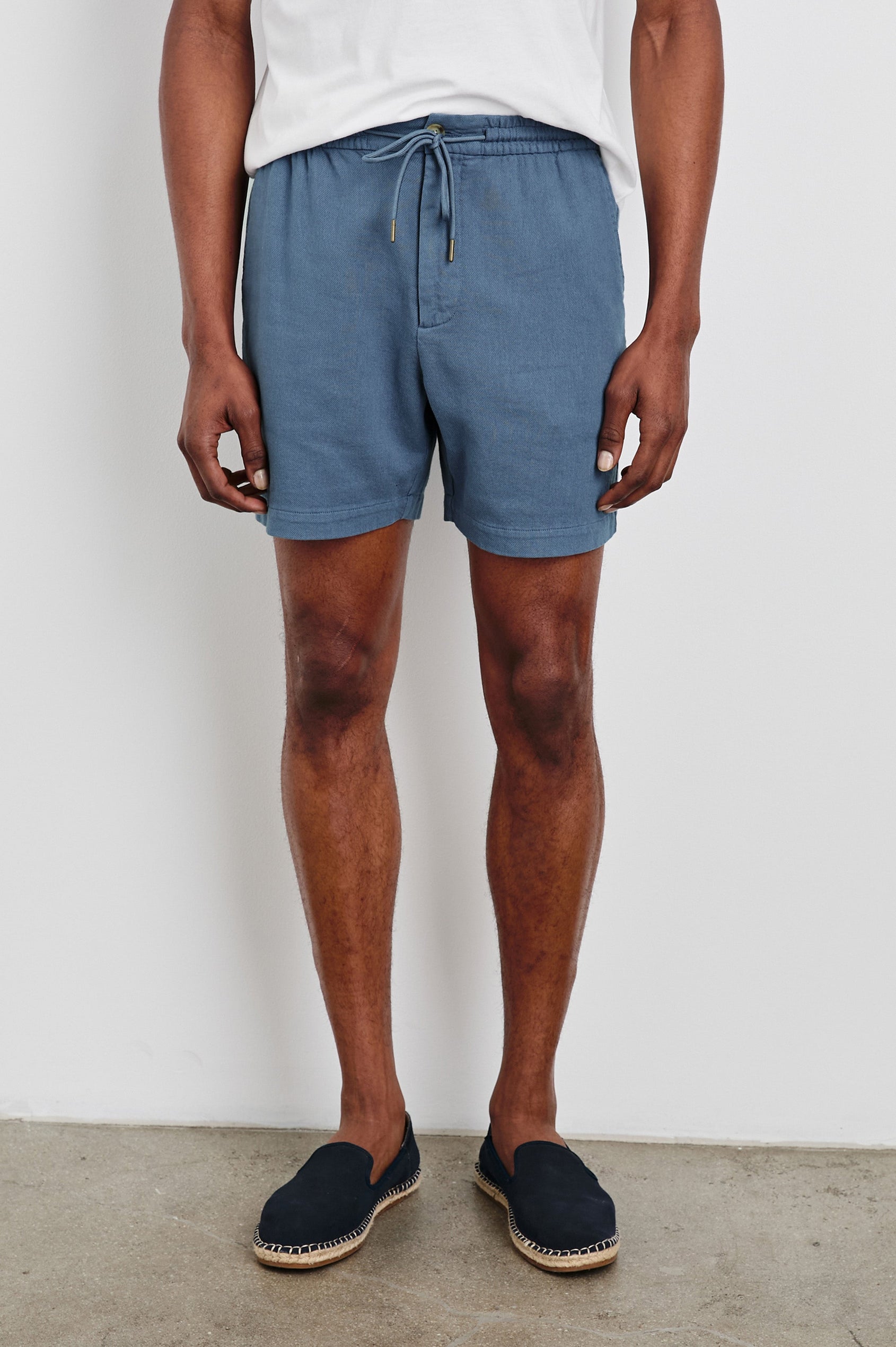 Archer 6" Shorts with a Drawstring Waist, Zipper Fly with Button, Two Front Pockets and a Back Patch Pocket in Washed Blue Colorway - Front View Featured on Model