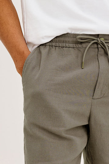 Archer Short in Unlined Cotton Linen With Relaxed Fit, Adjustable Waist Drawstring Ties, Side Pockts, and 6-Inch Inseam in Fallen Rock Colorway - Lower Body Close Up Front View Featured on Model