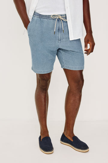 Archer Short in Unlined Cotton Linen With Relaxed Fit, Adjustable Waist Drawstring Ties, Side Pockts, and 8.5-Inch Inseam in Medium Wash Indigo Colorway - Lower Body Front View Featured on Model