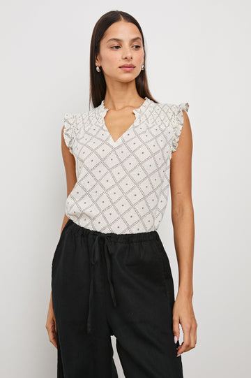 Arlene Top with Short Flutter Cap Sleeves, A V-Neckline and Shirring Along the Top Front in Ivory Zanzibar Colorway, a Dotted Black Grid on Ivory - Front Tucked View Featured on Model