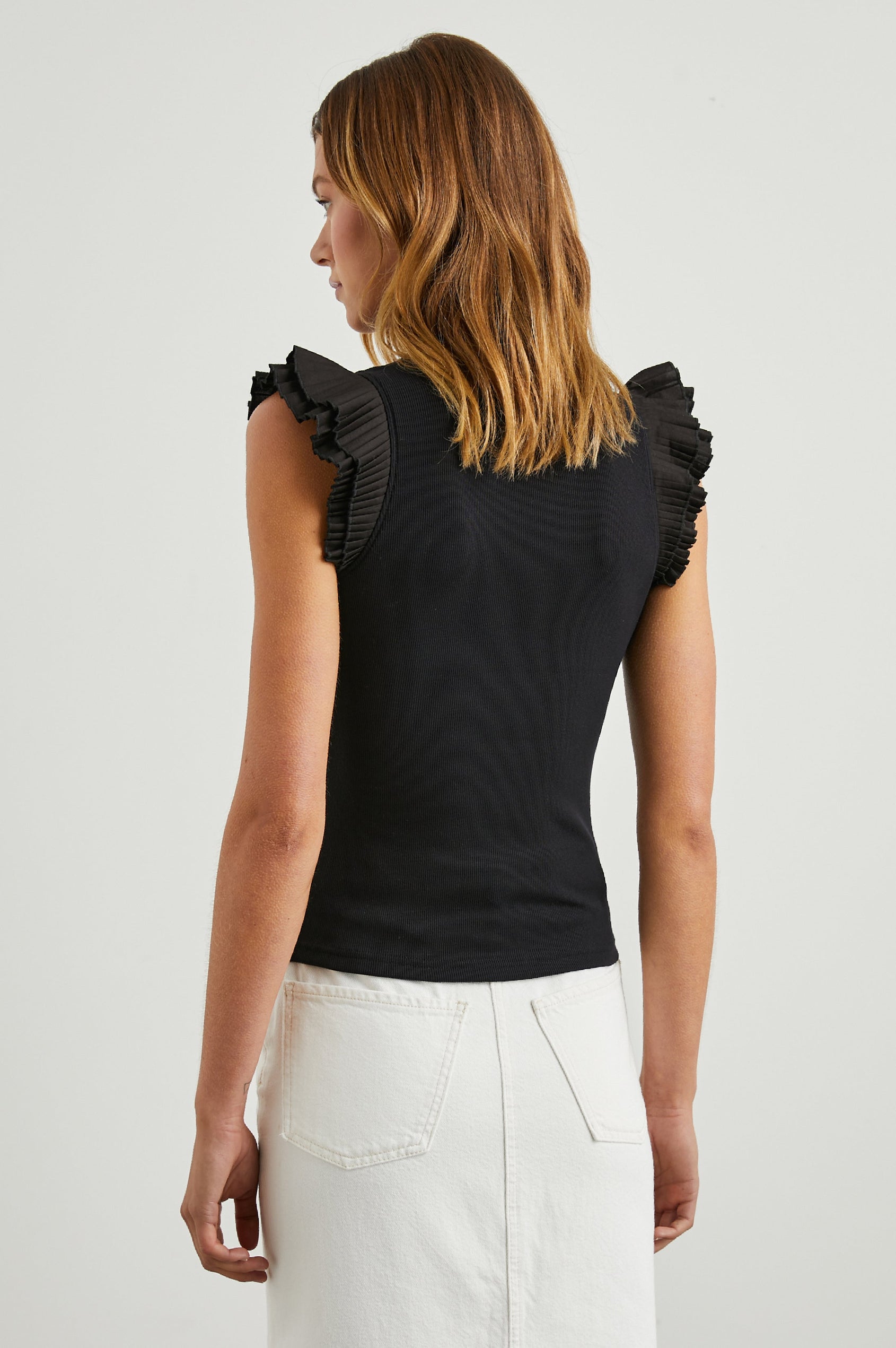Asha Short-Sleeve Ribbed Top with a Crew Neck and Pleated Flutter Sleeves in Black Colorway - Back View Featured on Model
