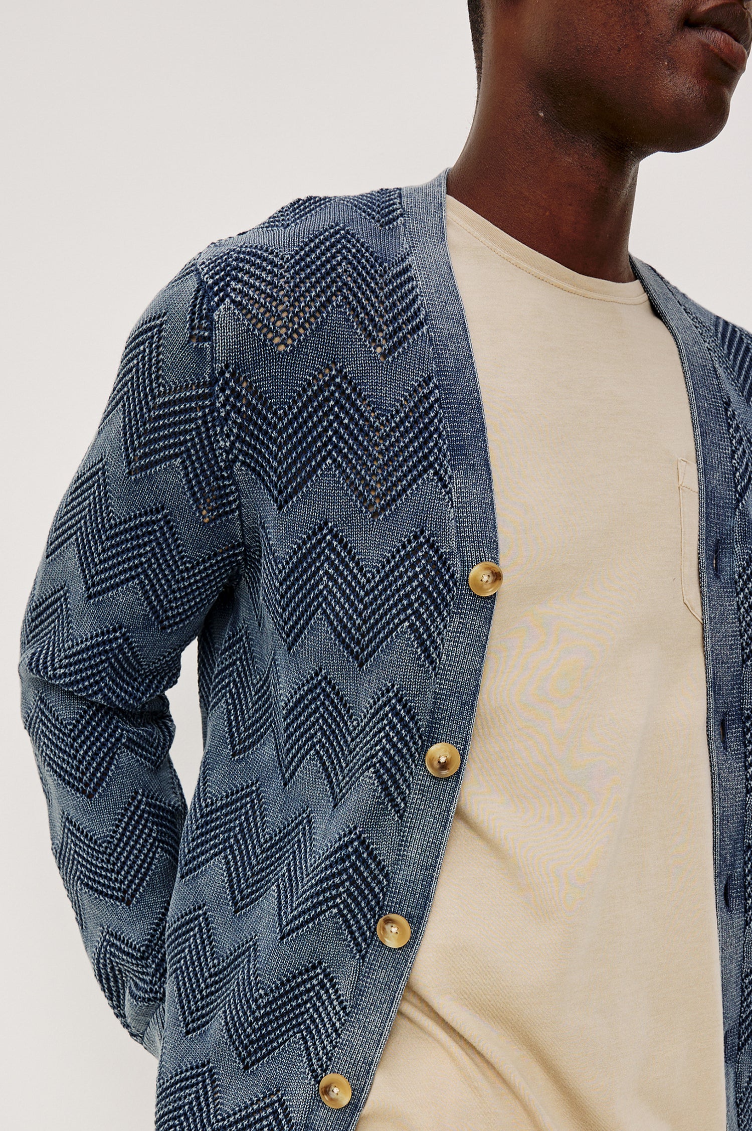 Ashe Cardigan Sweater in Jacquard Knit With Unique Spray-Wash Finish, Front Buttons, Regular Fit, and Long Sleeves in Sunfaded Navy Colorway - Upper Body Front Close Up View Featured on Model