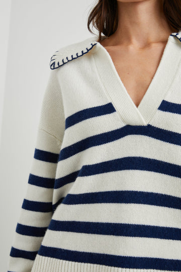 Athena Long-Sleeve Sweater with a Flat Collar V Neckline, Ribbed Cuffs and Hem and Contrast Stitching at the Cuffs and Hem in Ivory Navy Stripe Colorway, Horizontal Stripes - Front View Featured on Model 