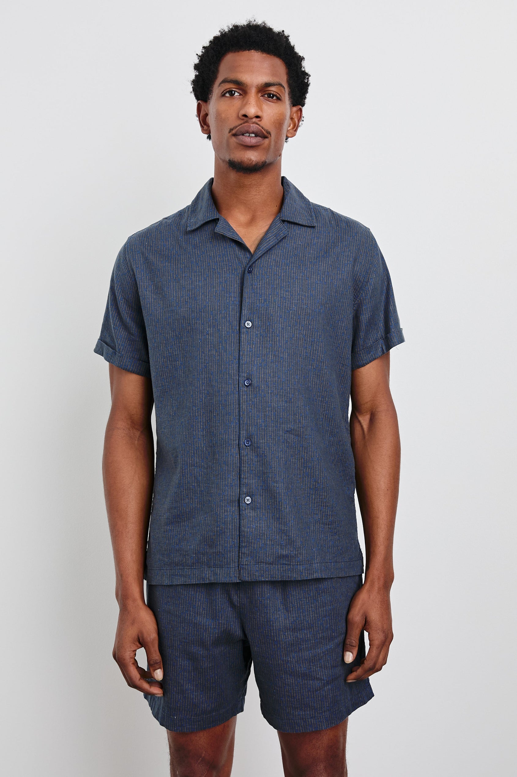 Atlas Short-Sleeve Button Up in Navy Cedar Vertical Colorway, with Thin Vertical Cedar Dashes on Navy - Front View Featured on Model