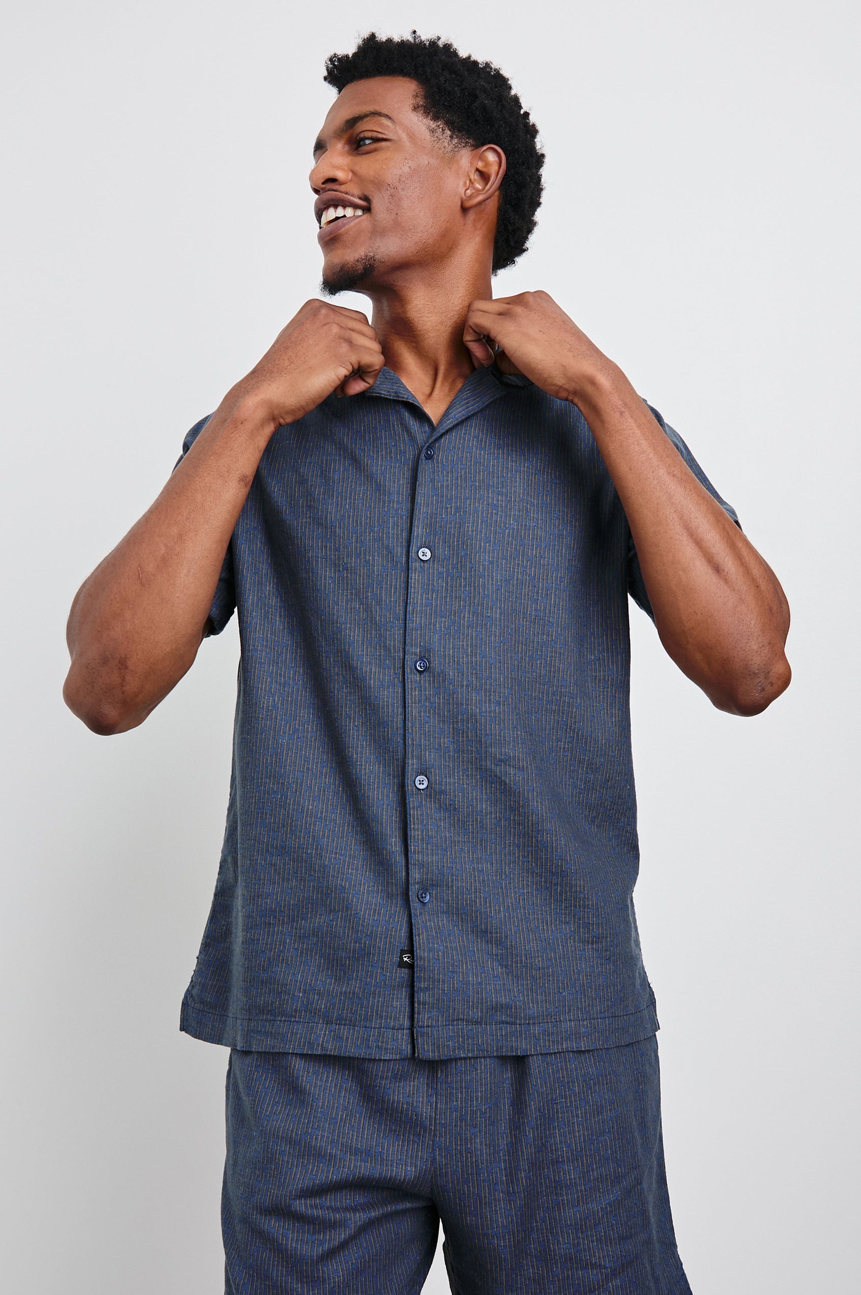 Atlas Short-Sleeve Button Up in Navy Cedar Vertical Colorway, with Thin Vertical Cedar Dashes on Navy - Front View Featured on Model