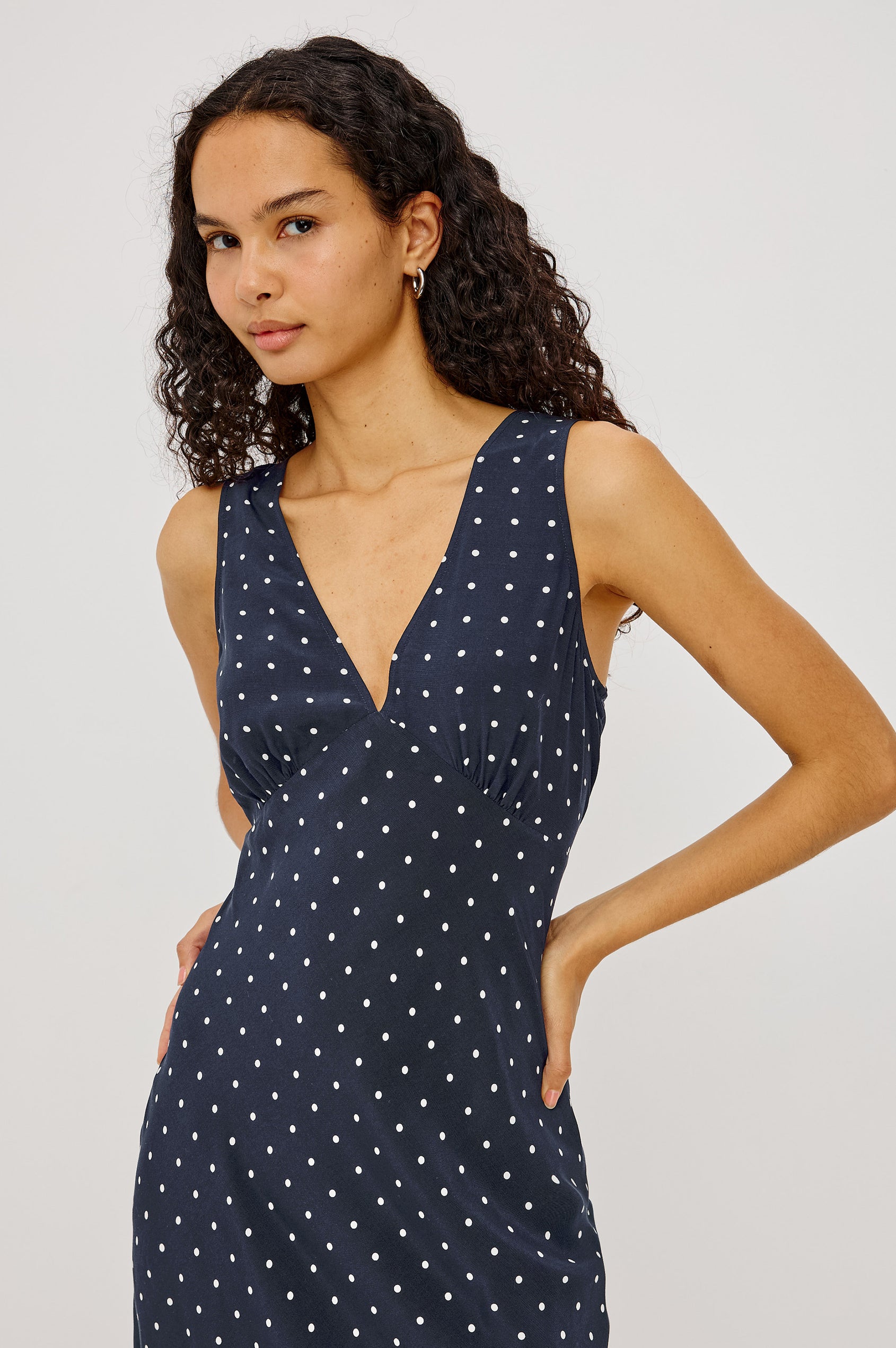 Audrina Midi Dress in Crepe Blend Bias Cut With Plunging V-Neckline in Navy Polka Dots Colorway - Upper Body Front View Featured on Model