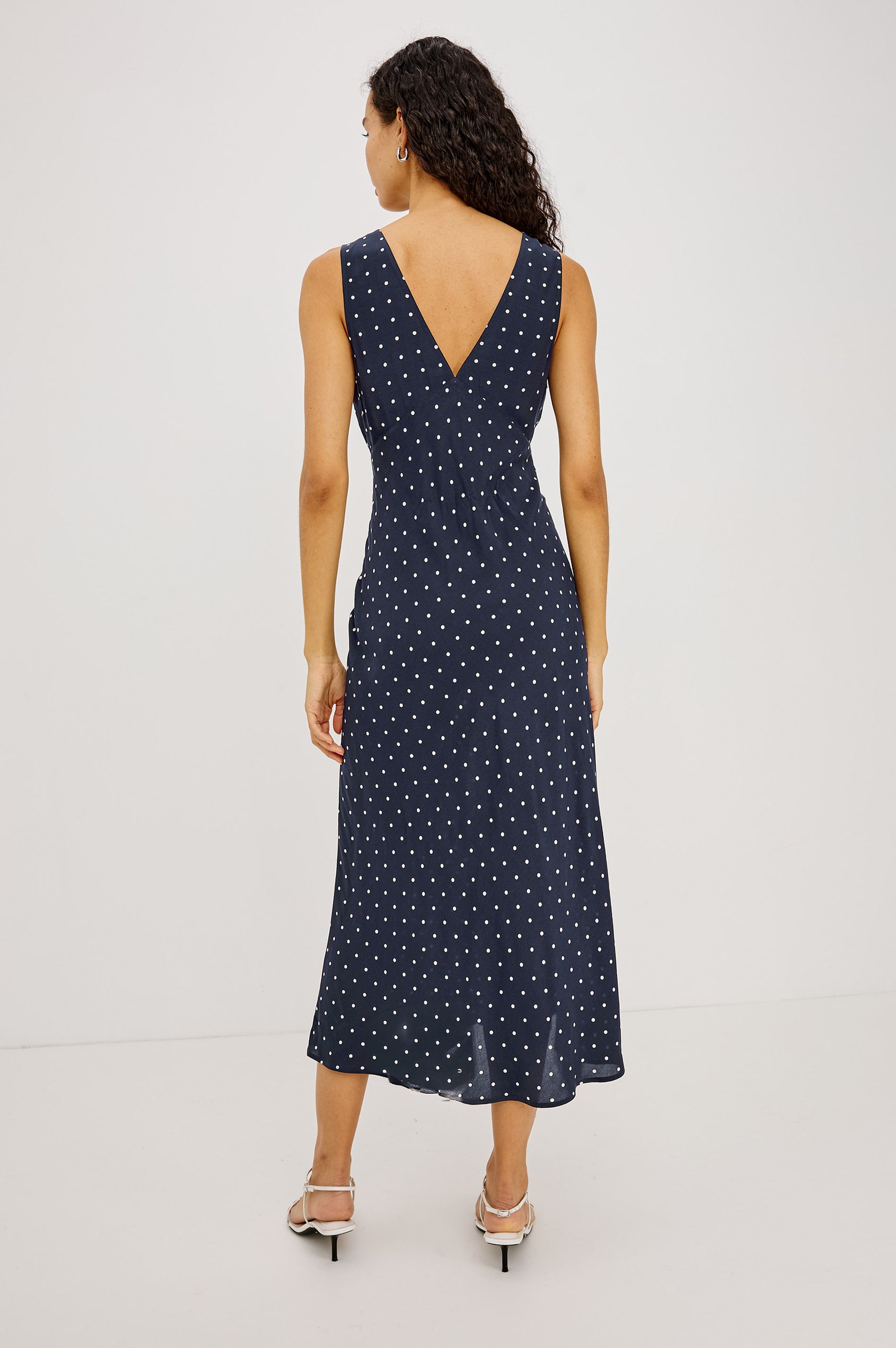Audrina Midi Dress in Crepe Blend Bias Cut With Plunging V-Neckline in Navy Polka Dots Colorway - Full Body Back View Featured on Model
