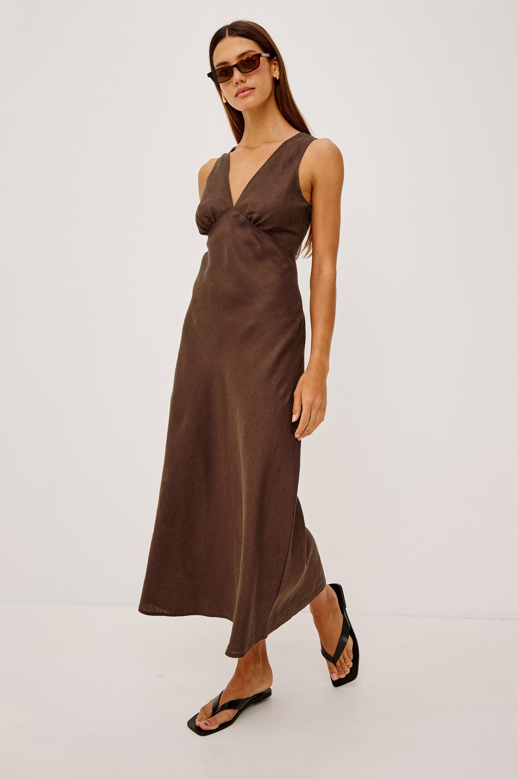 Avianna Midi Dress in Linen With Sleeveless Bias Cut, Plunging V-Neckline, Empire Waist, and Hidden Side Zip in Espresso Colorway - Full Body Front View Featured on Model