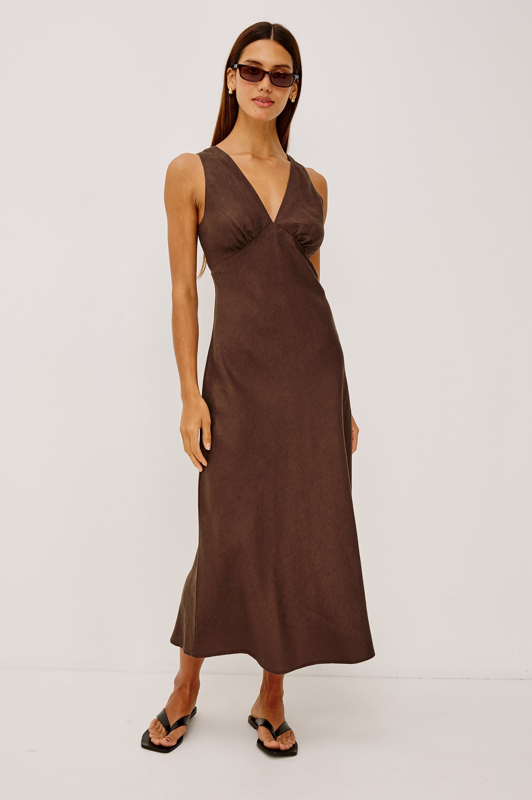 Avianna Midi Dress in Linen With Sleeveless Bias Cut, Plunging V-Neckline, Empire Waist, and Hidden Side Zip in Espresso Colorway - Full Body Front View Featured on Model
