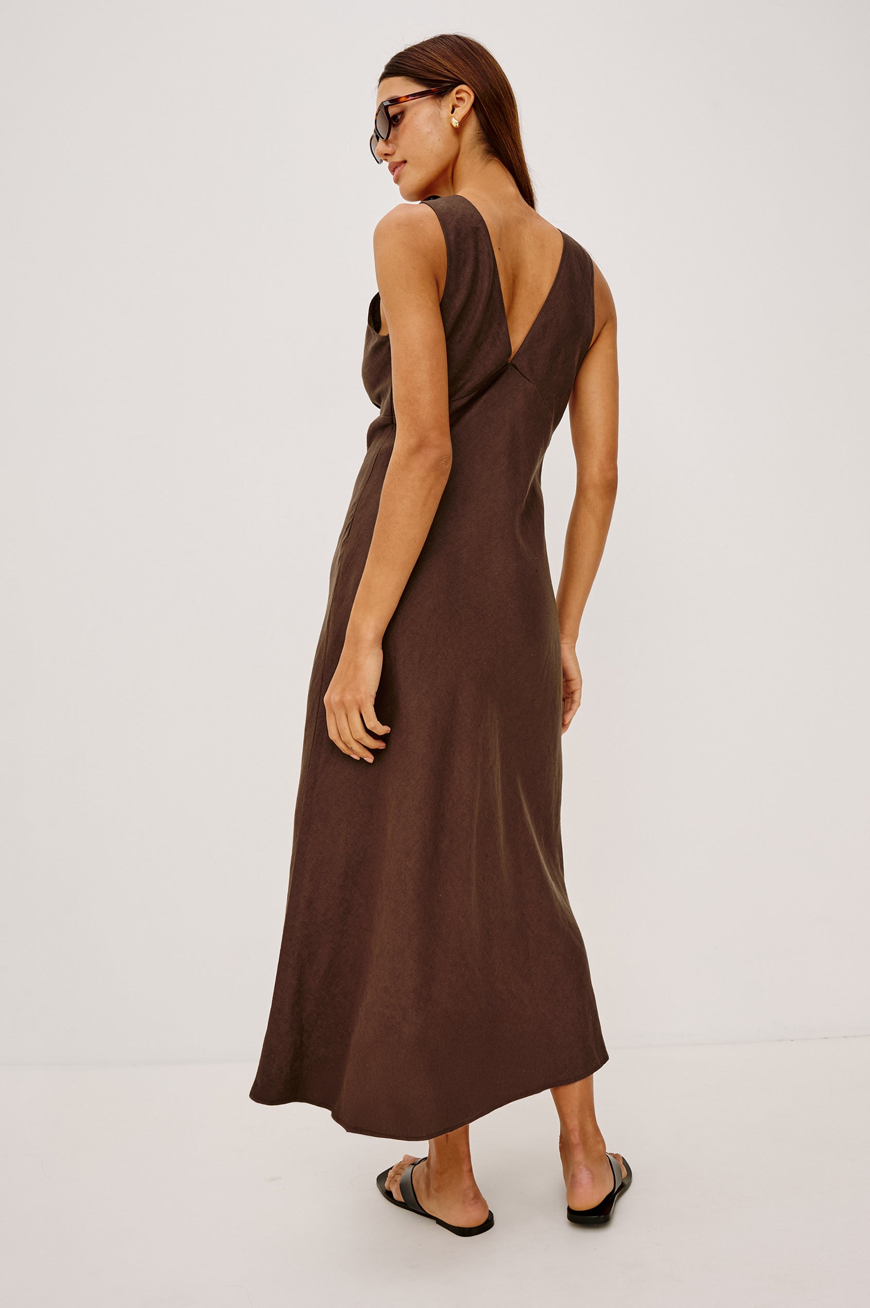 Avianna Midi Dress in Linen With Sleeveless Bias Cut, Plunging V-Neckline, Empire Waist, and Hidden Side Zip in Espresso Colorway - Full Body Back View Featured on Model