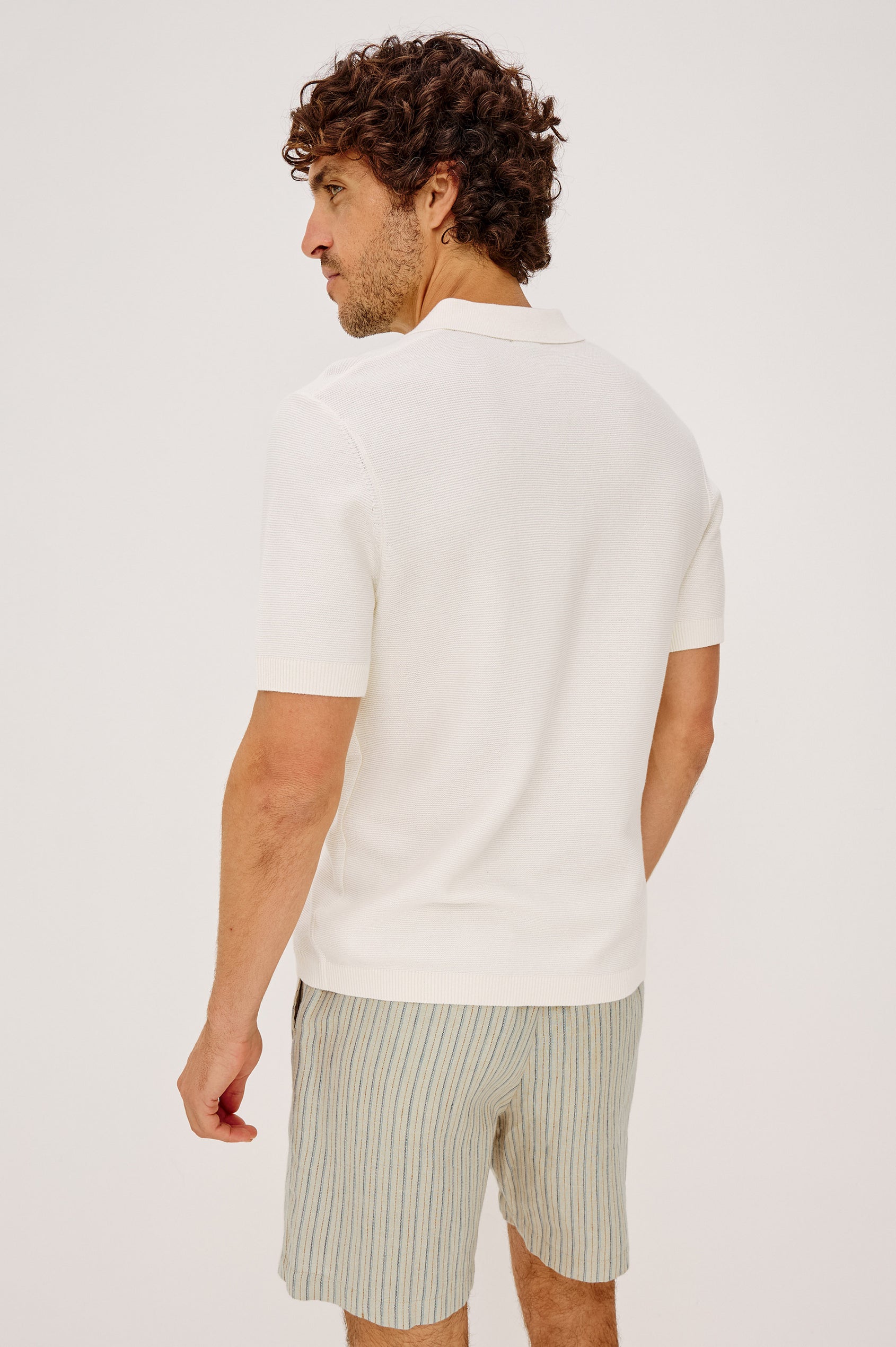 Baker Polo Shirt in Rib Cotton Knit With Colar, Short Sleeves, and Relaxed Fit in Ivory Colorway - Upper Body Back View Featured on Model