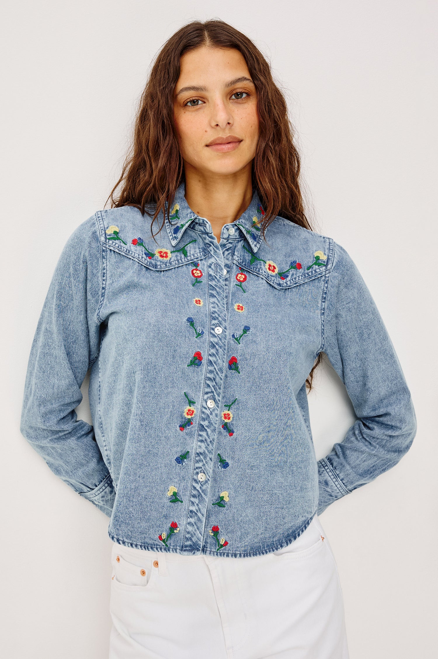 Bari Shirt in Cotton Chambray With Collar, Front Buttons, and Long Sleeves in Indigo Floral Embroidery Colorway - Upper Body Front VIew Featured on Model