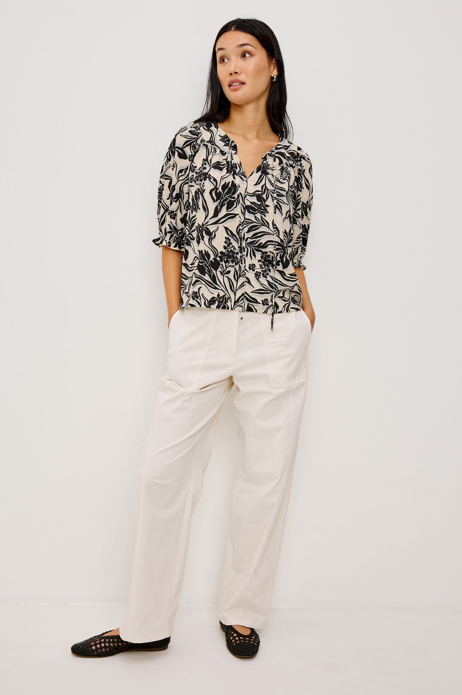 Belina Peasant Top in Crinkle Poplin With Gathered V-Neckline With Self Ties, Blanket Stitch Embroidered Trim, Loose Fit, and Elbow-Length Puff Sleeves With Elastic Cuffs in Zinya Colorway - Full Body Front View Featured on Model