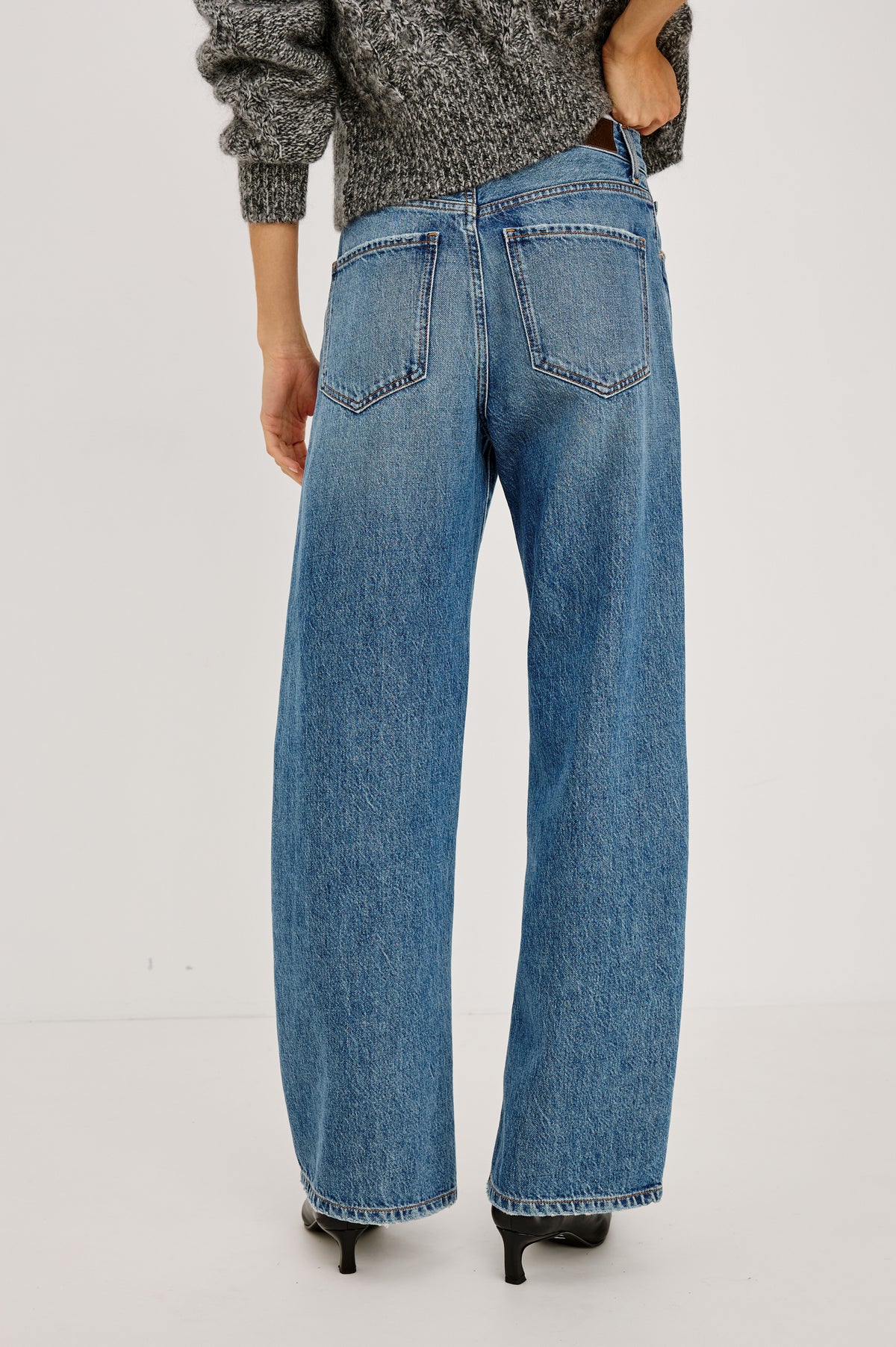 Belmont Arc Leg Jean in Rigid Denim With High Rise, Distressed Detailing, Button Fly, and 5-Pockets in Homestead Colorway - Back View Featured on Model